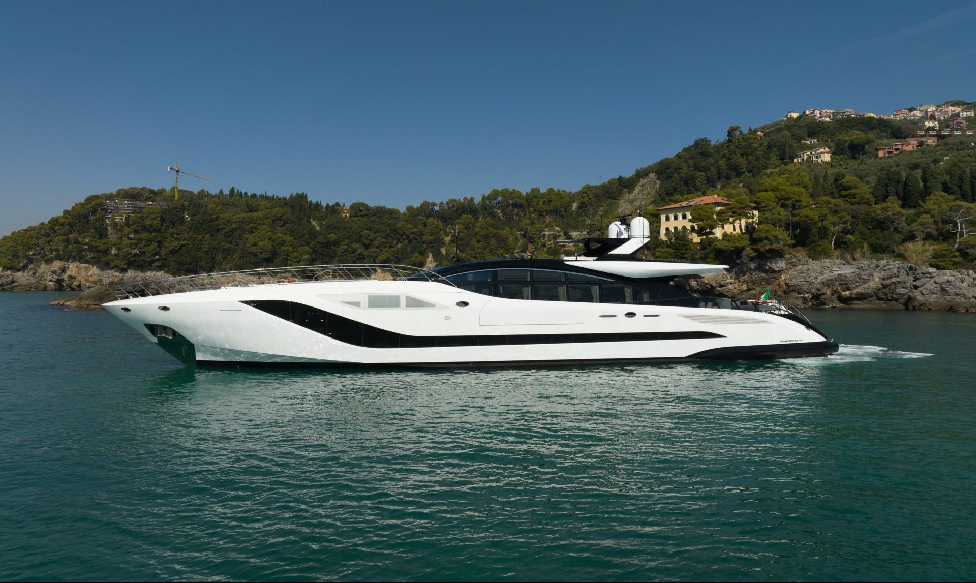Mangusta yacht cruising along scenic coastline