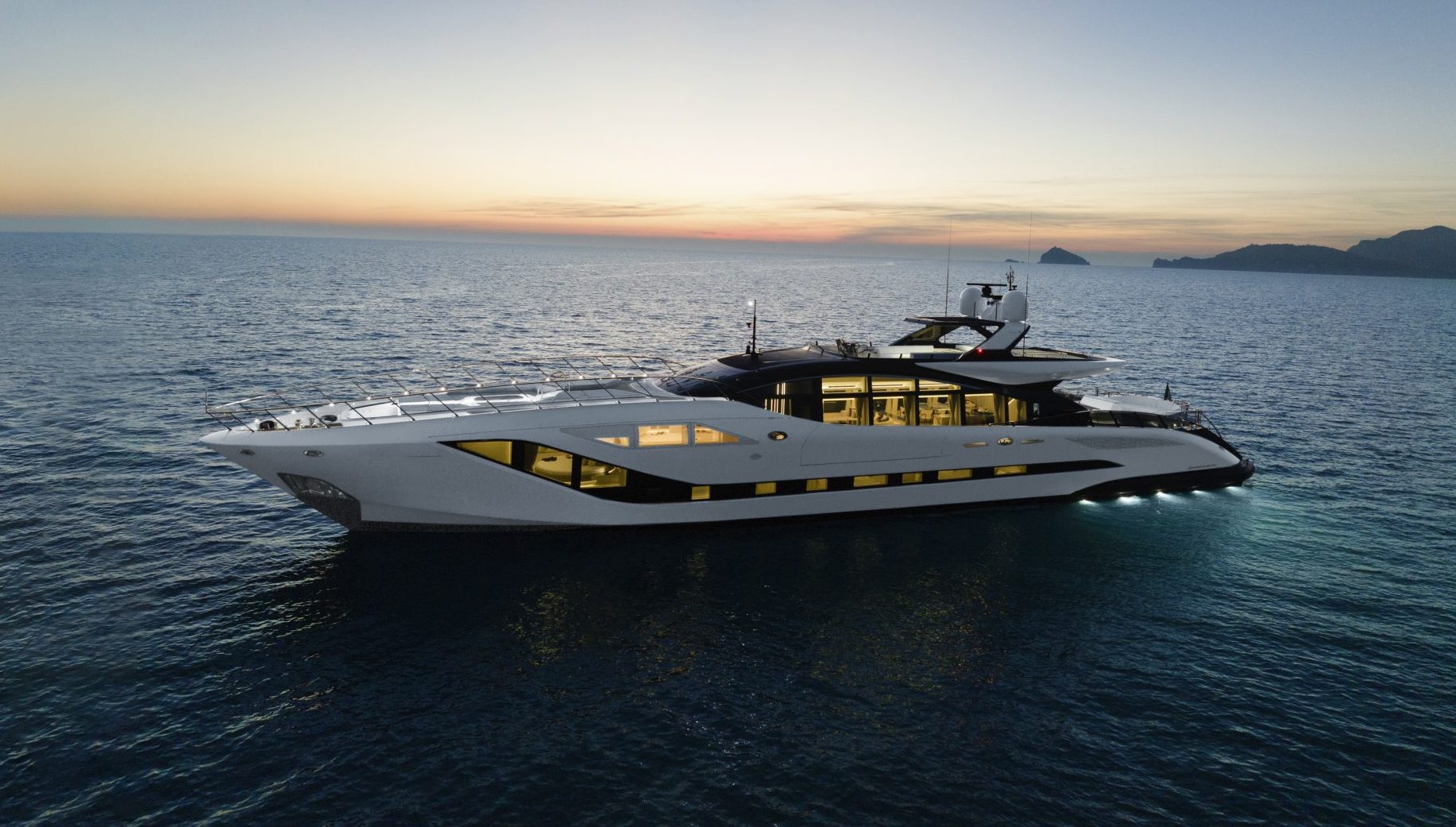 Luxury Mangusta yacht cruising at sunset