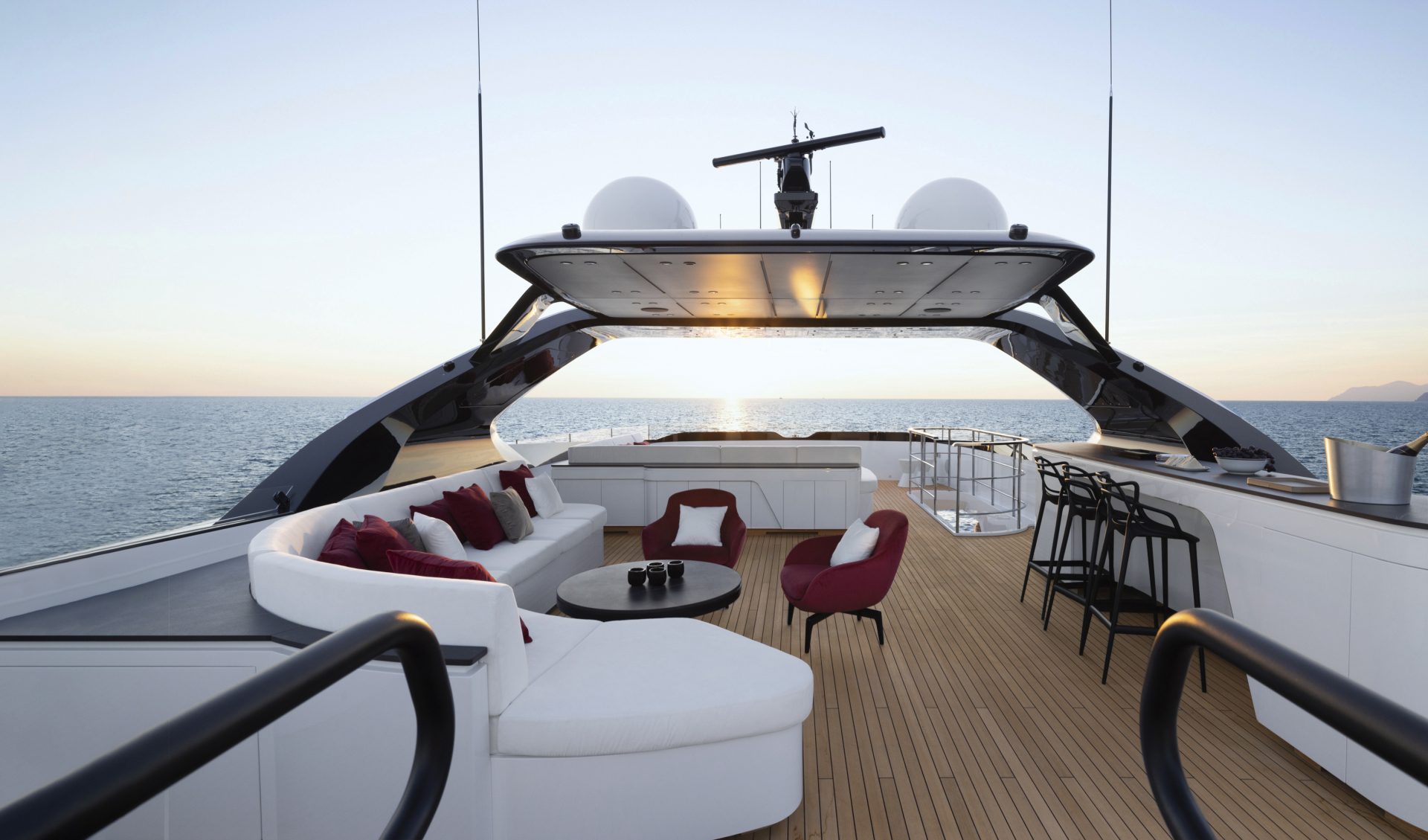 Luxurious deck on Mangusta yacht at sunset.