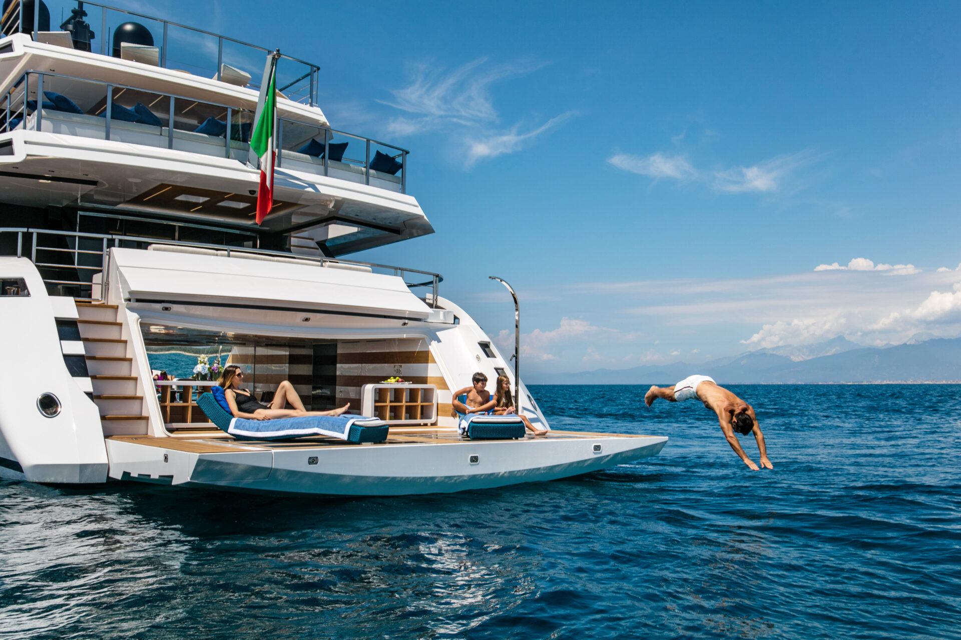 Luxury Mangusta yacht with people enjoying the sea
