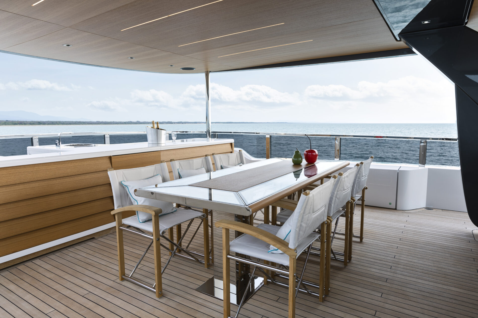 Luxury yacht deck with table and ocean view