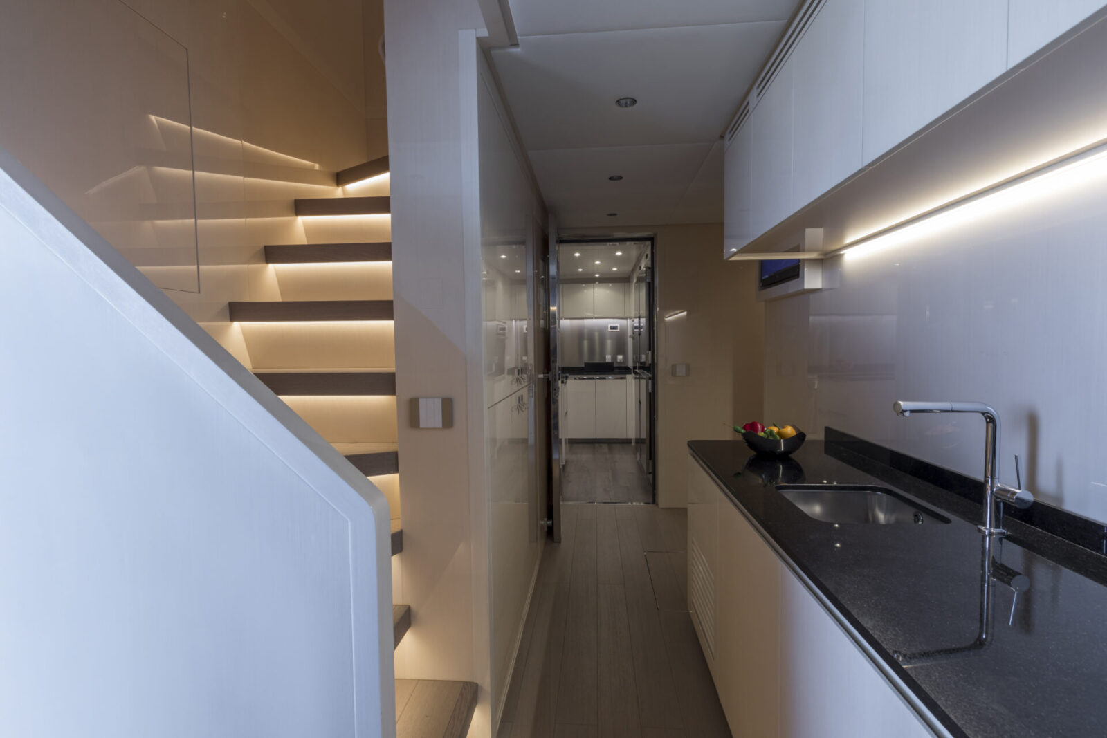 Luxurious yacht interior with sleek staircase.