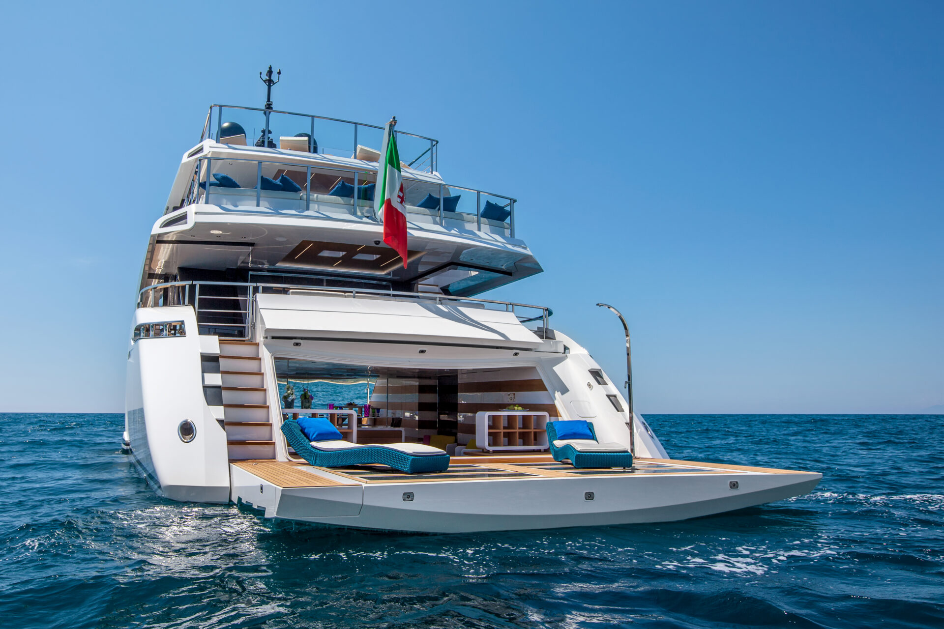 Luxurious Mangusta yacht on open sea, rear view.