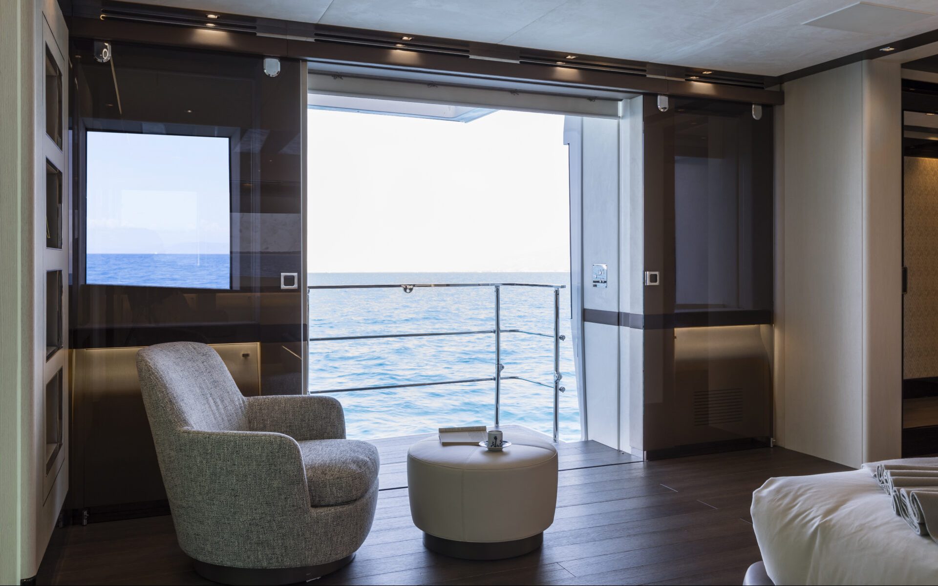 Luxurious yacht cabin with sea view balcony.