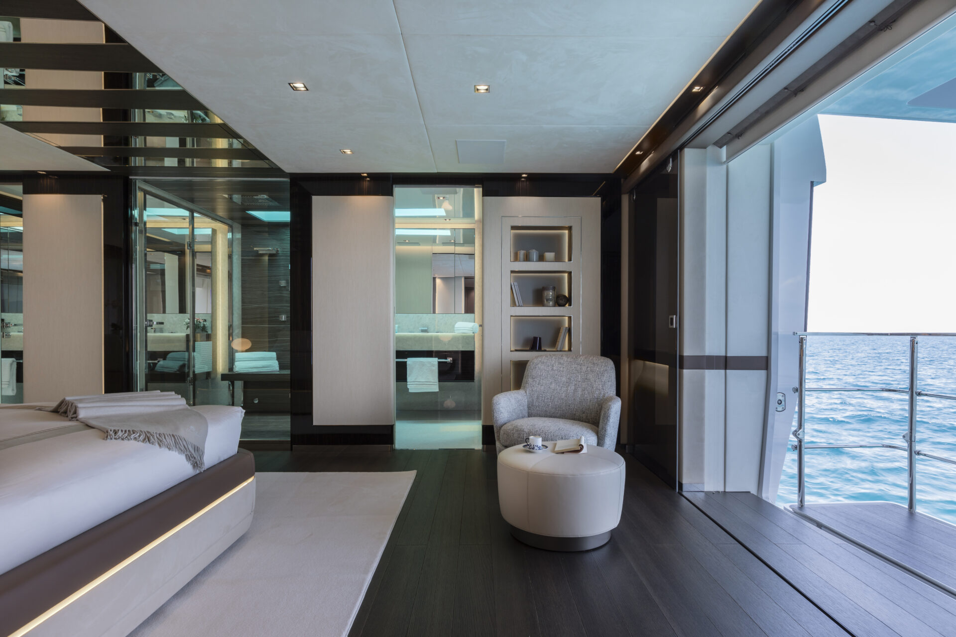 Luxurious yacht bedroom with ocean view and balcony.