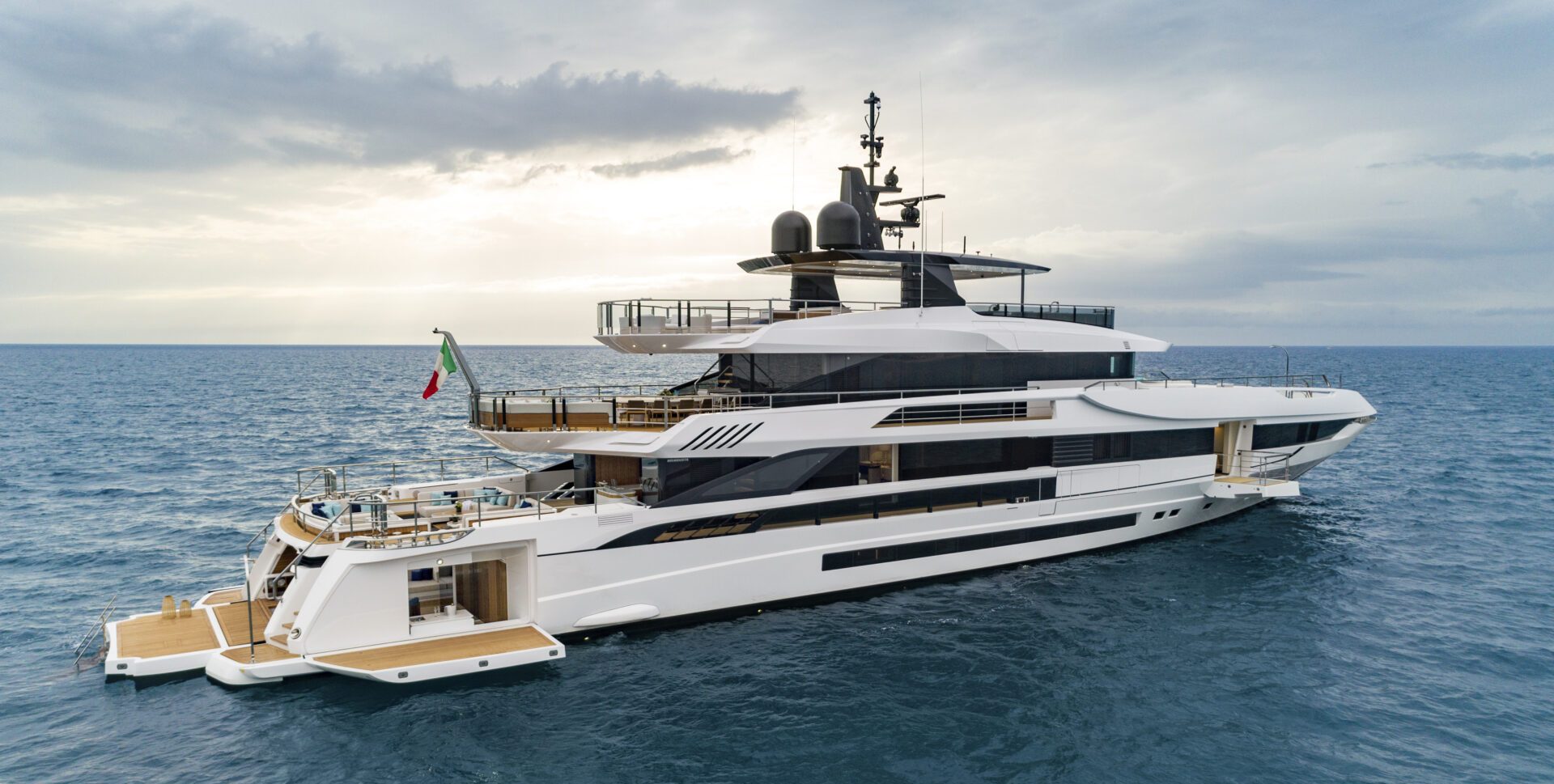 Luxury Mangusta yacht sailing in open sea.