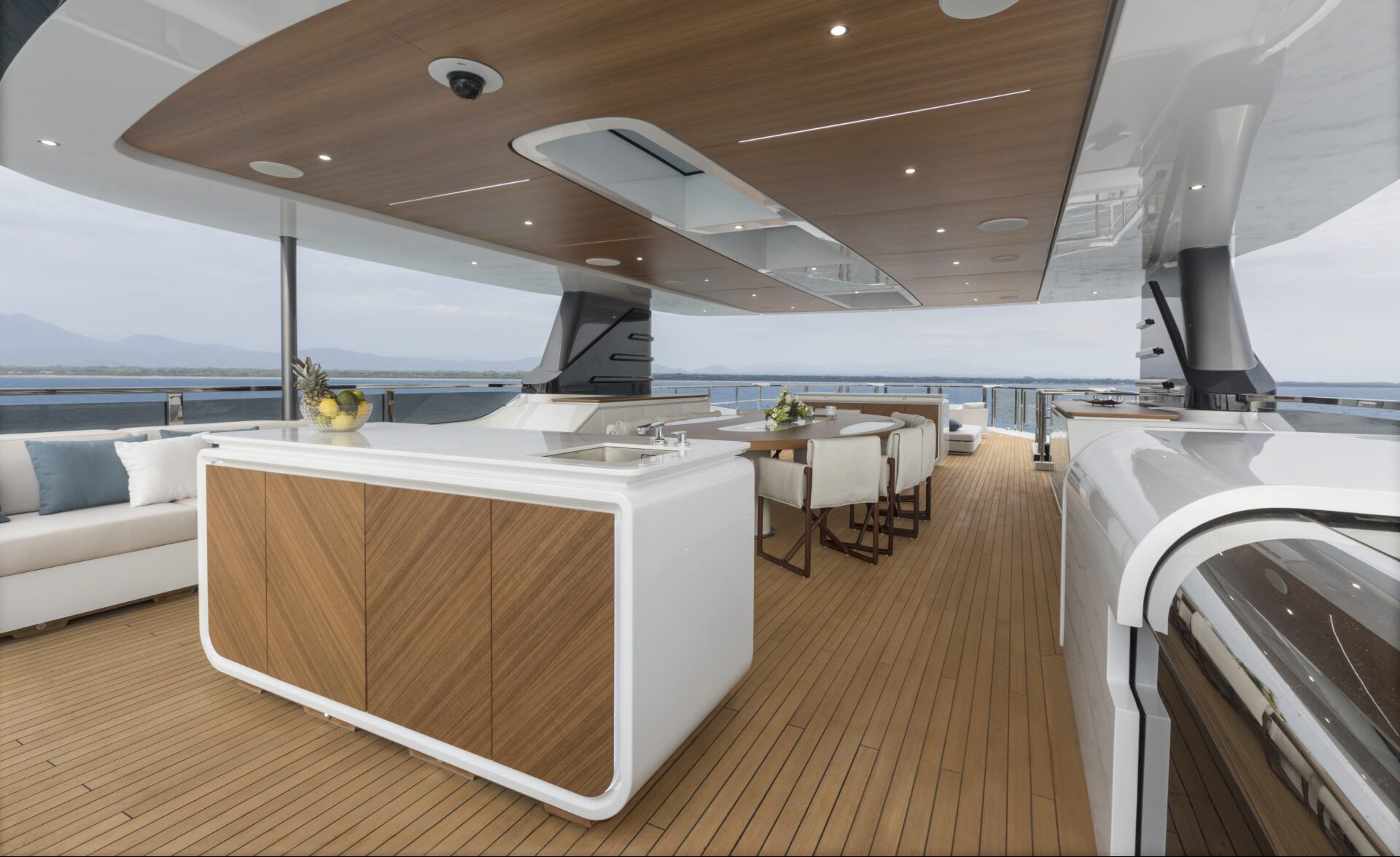 Luxurious open deck of Mangusta yacht with sea view.