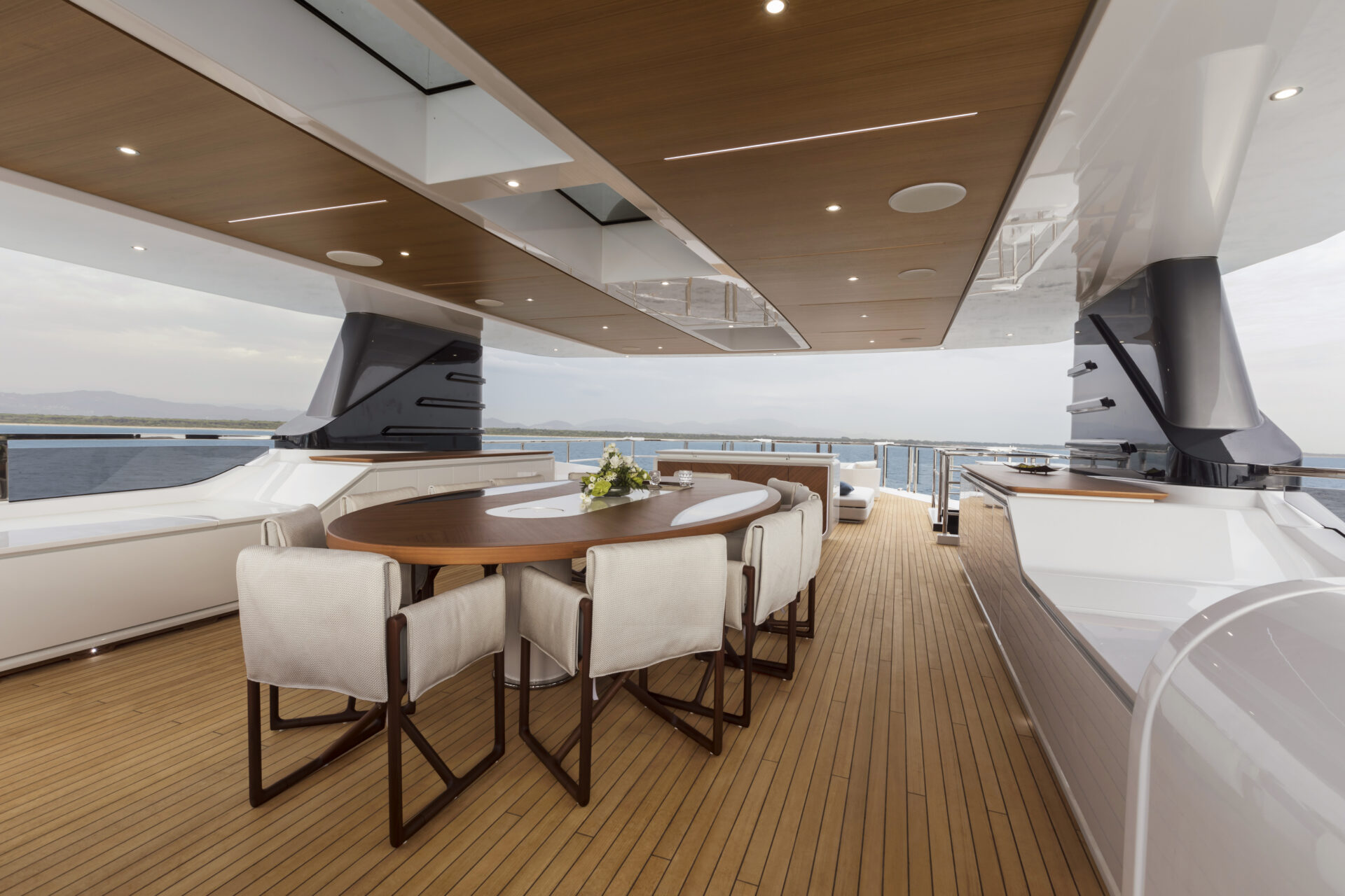 Luxurious yacht deck with dining table and ocean view