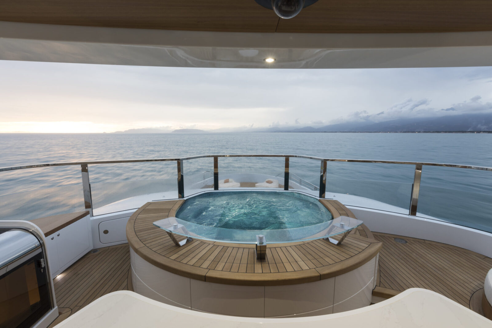 Yacht deck with jacuzzi overlooking the ocean.