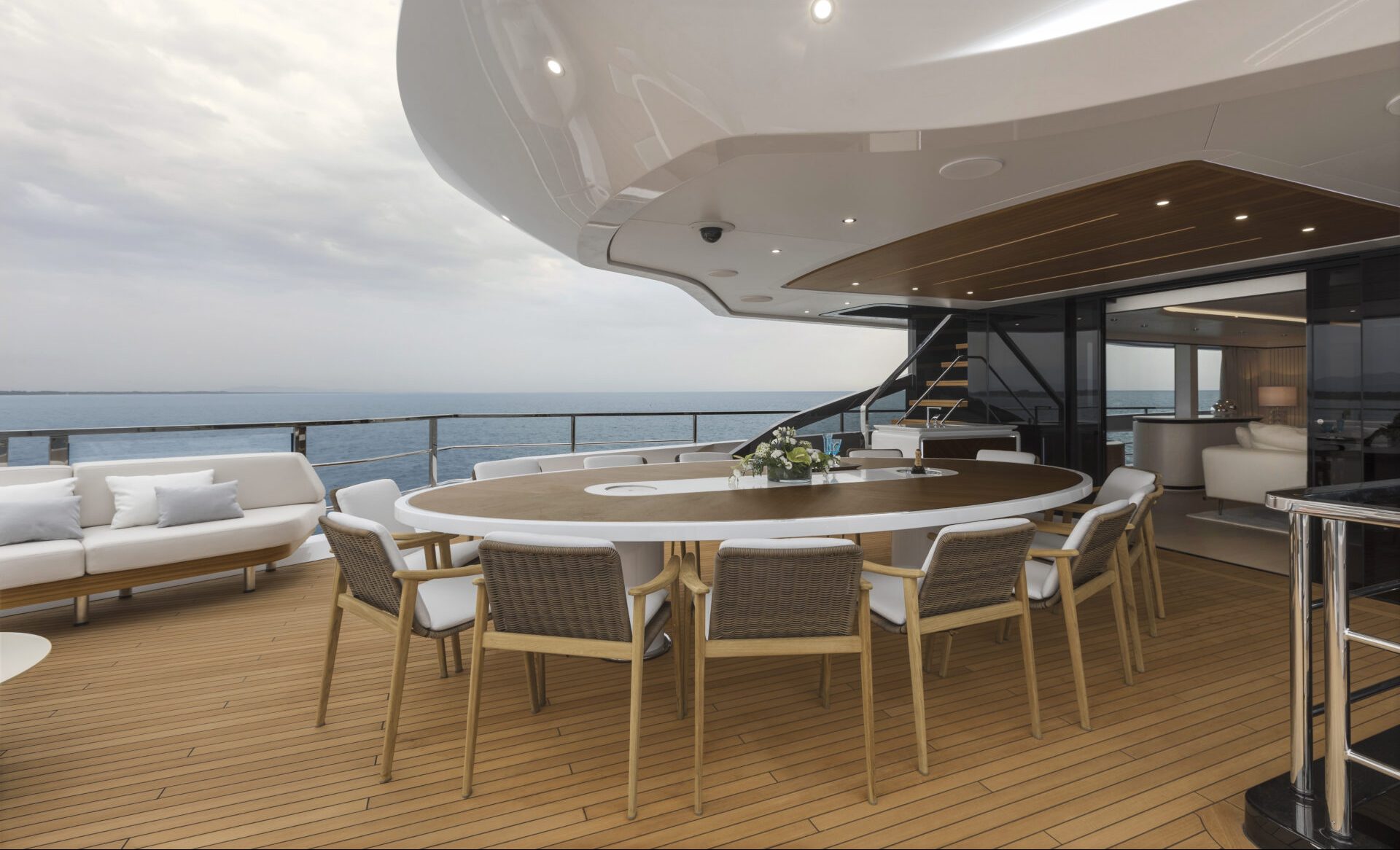 Spacious Mangusta Yachts deck with dining area.