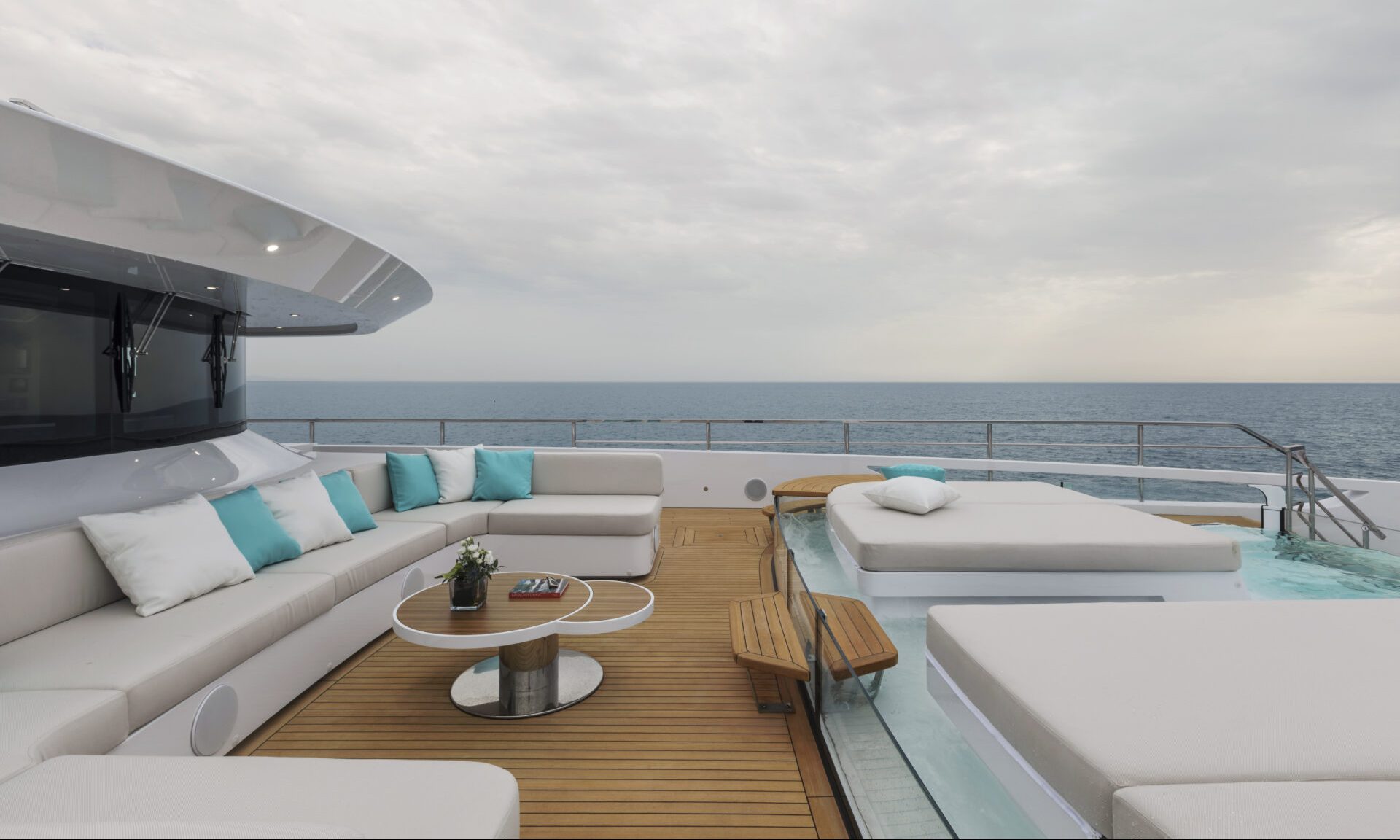 Luxury yacht deck with ocean view and lounge area.