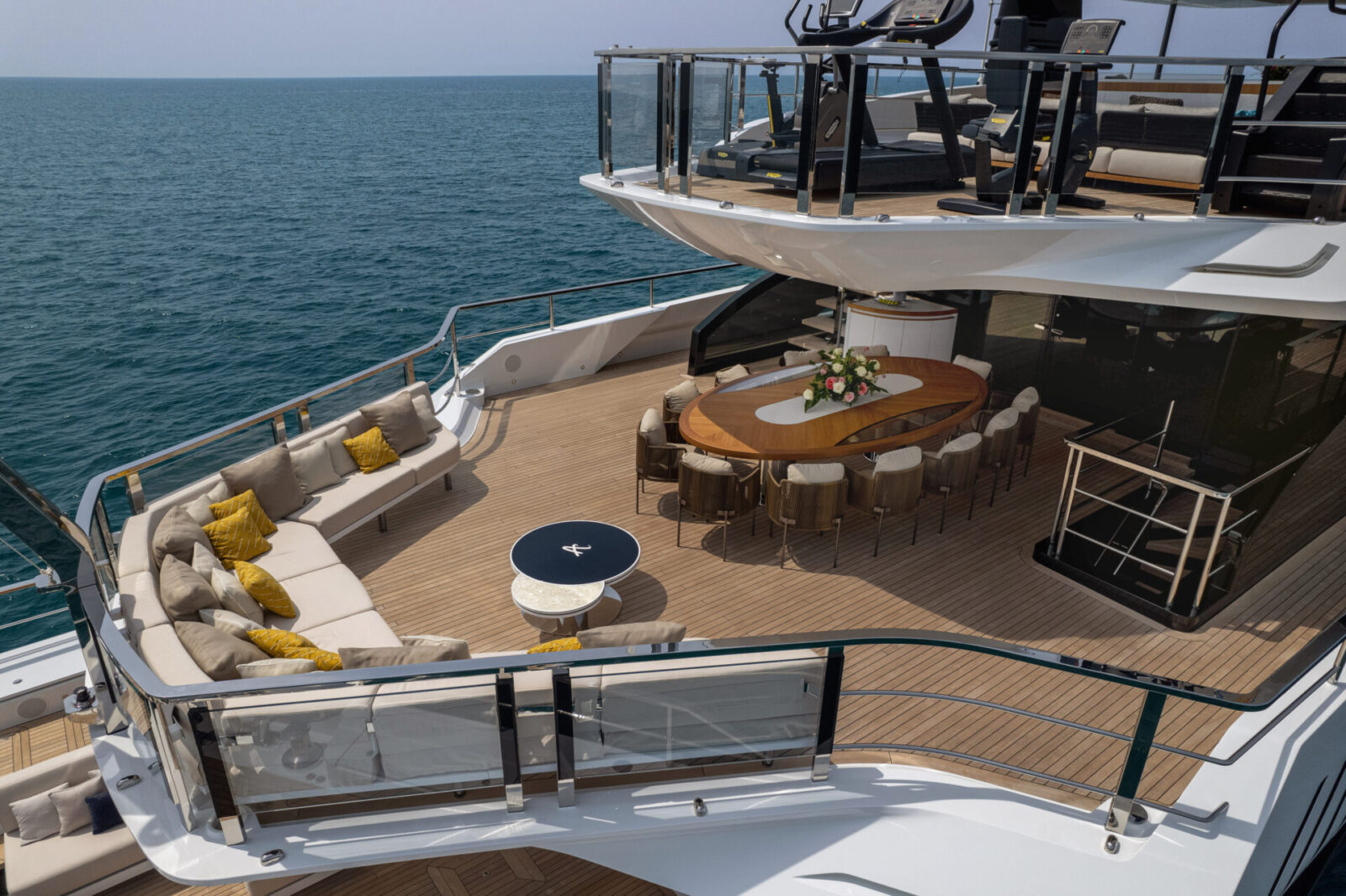 Luxury yacht deck with seating and dining area.