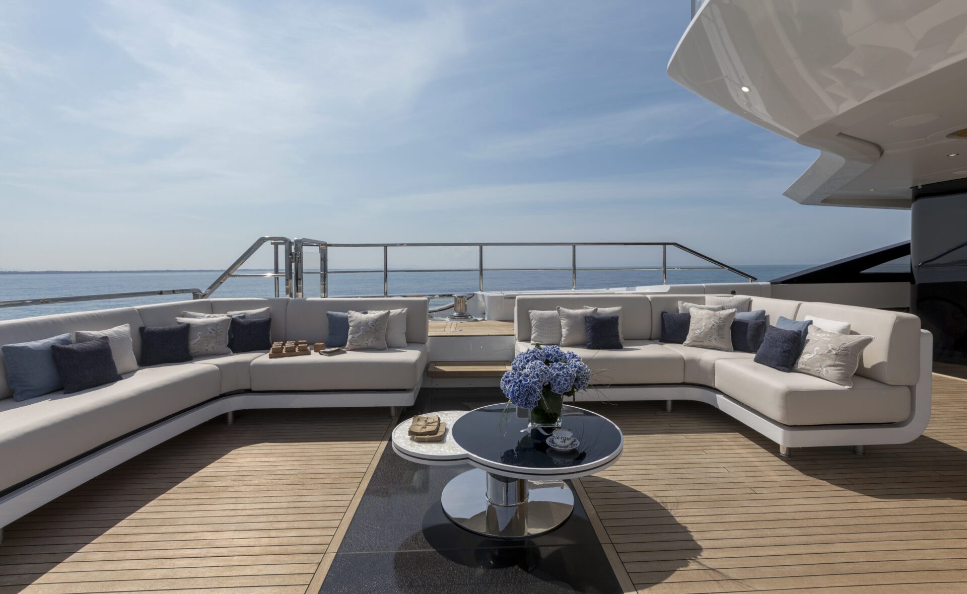 Area relax bordo Mangusta Yachts con divani e tavolo.