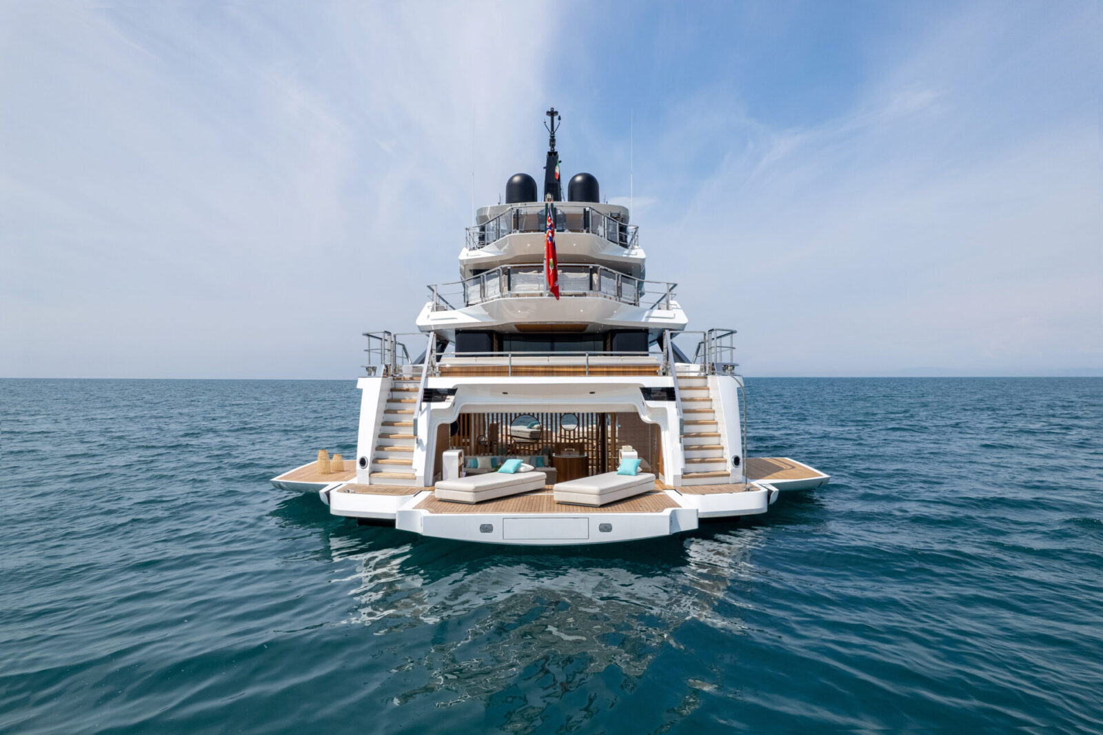 Luxury Mangusta yacht on open sea, stern view.