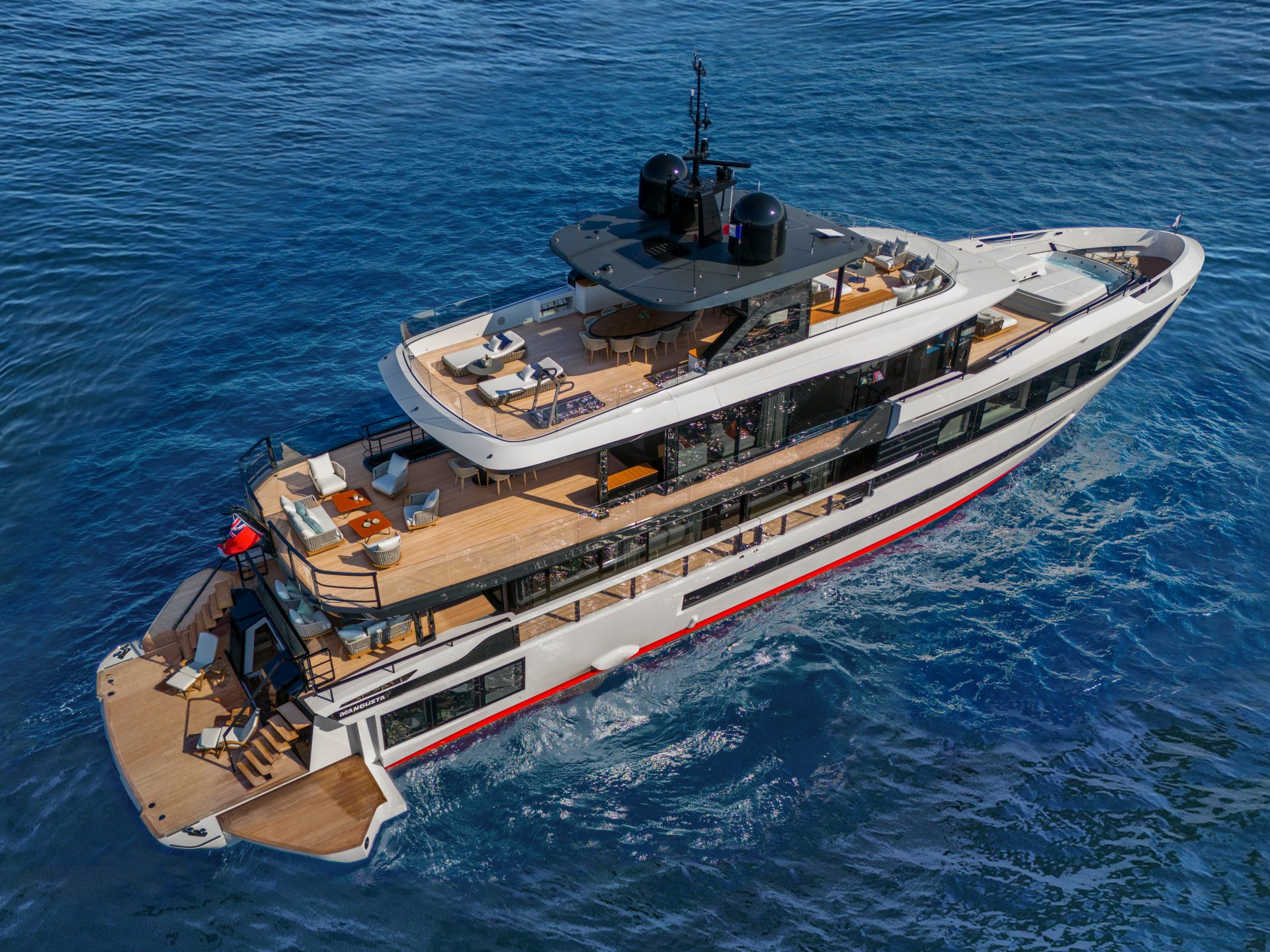 Luxury Mangusta yacht cruising on open sea.