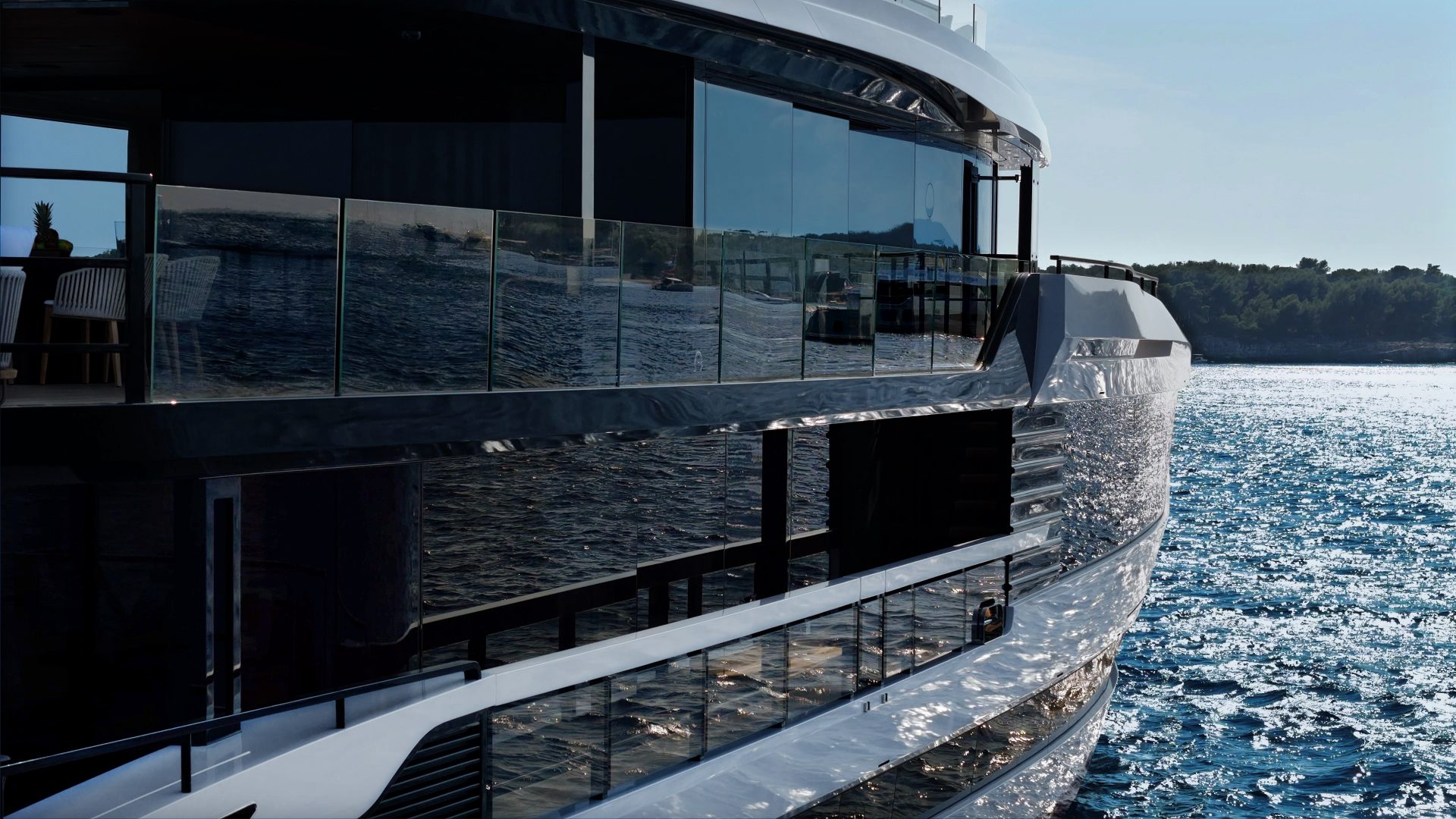 Reflective surface of a sleek Mangusta yacht at sea.