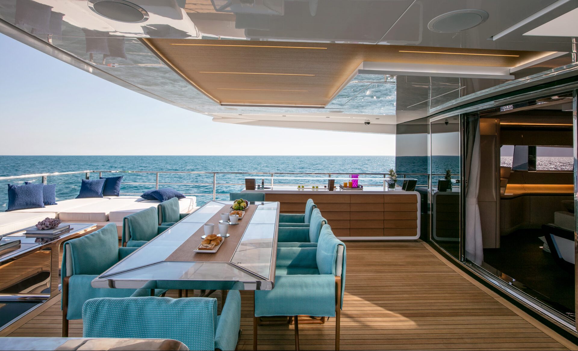Luxury yacht deck with dining area and ocean view
