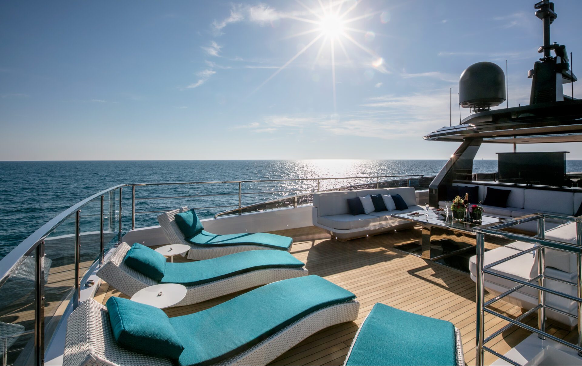 Luxurious Mangusta yacht deck with sun loungers.