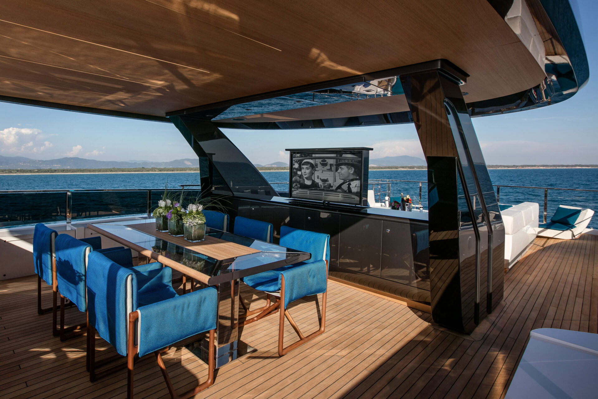 Luxury yacht deck with dining area and ocean view
