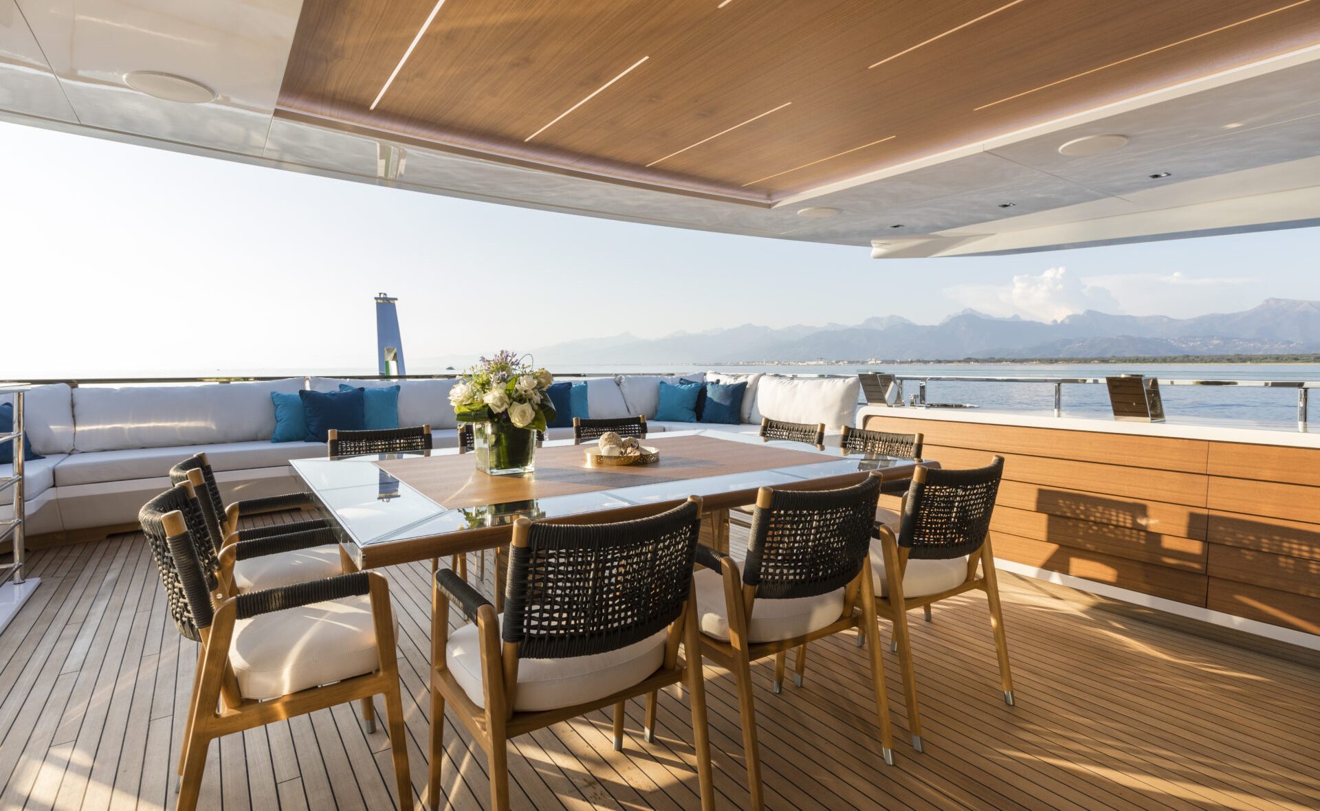 Elegant yacht deck with dining area and sea view