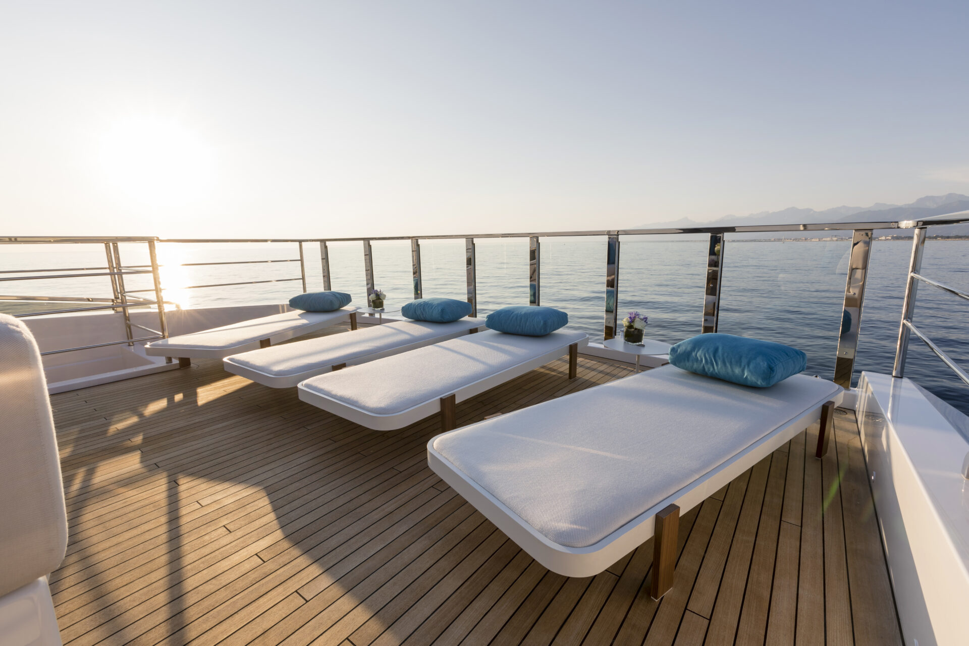 Sunlit deck with loungers on Mangusta Yacht