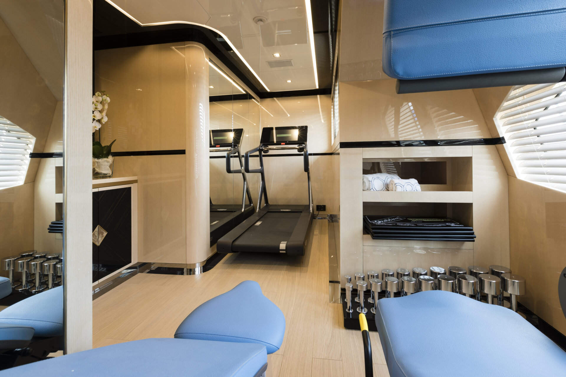 Luxurious gym on Mangusta Yacht with treadmill.
