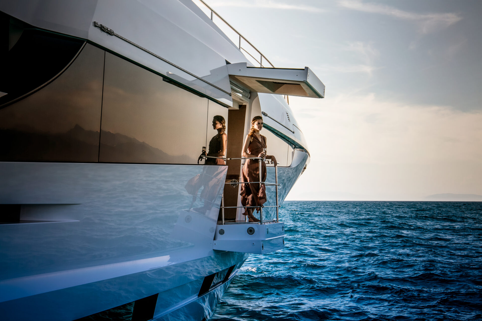 Luxury yacht exterior with woman admiring ocean view
