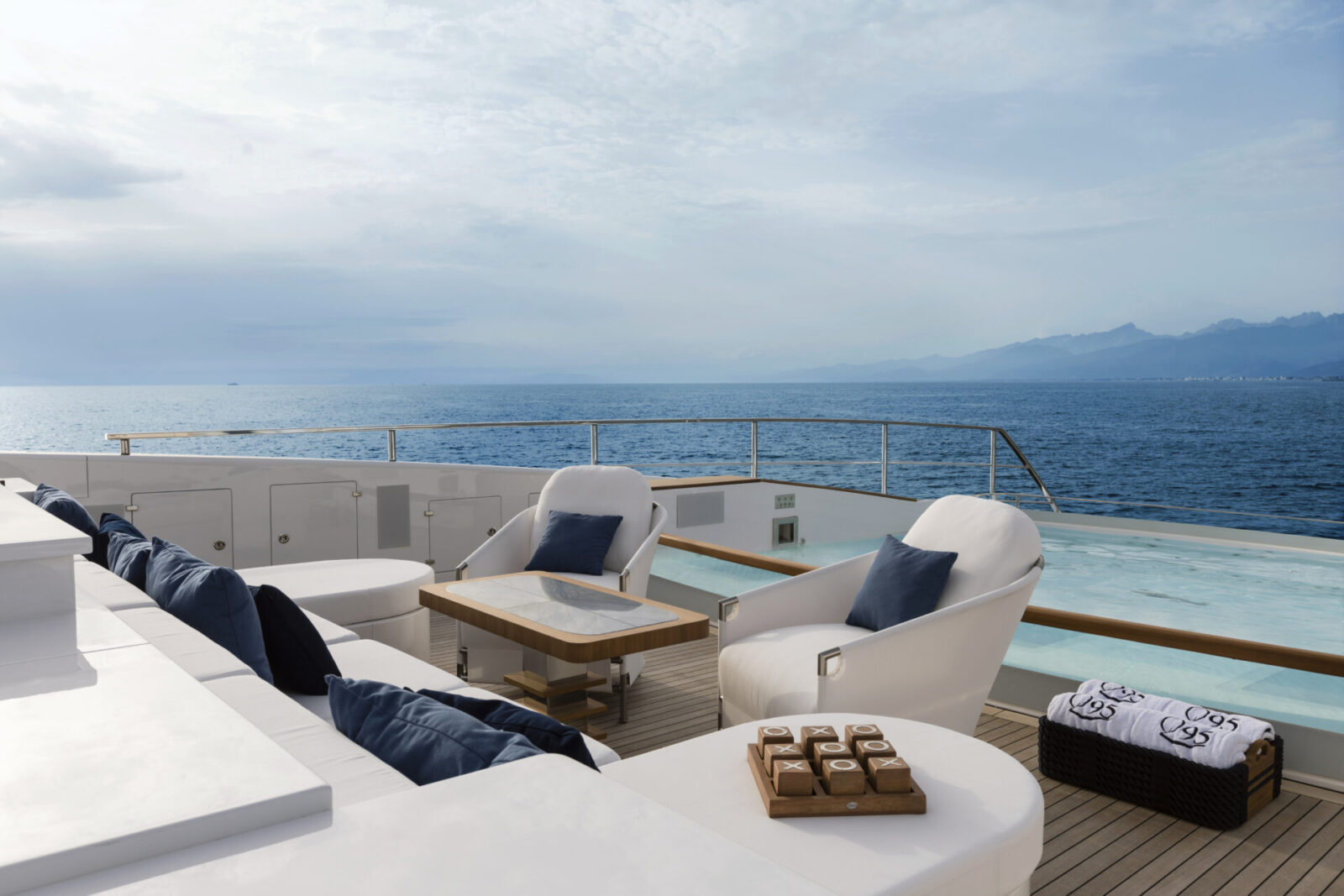 Luxurious yacht deck with sea view and seating.
