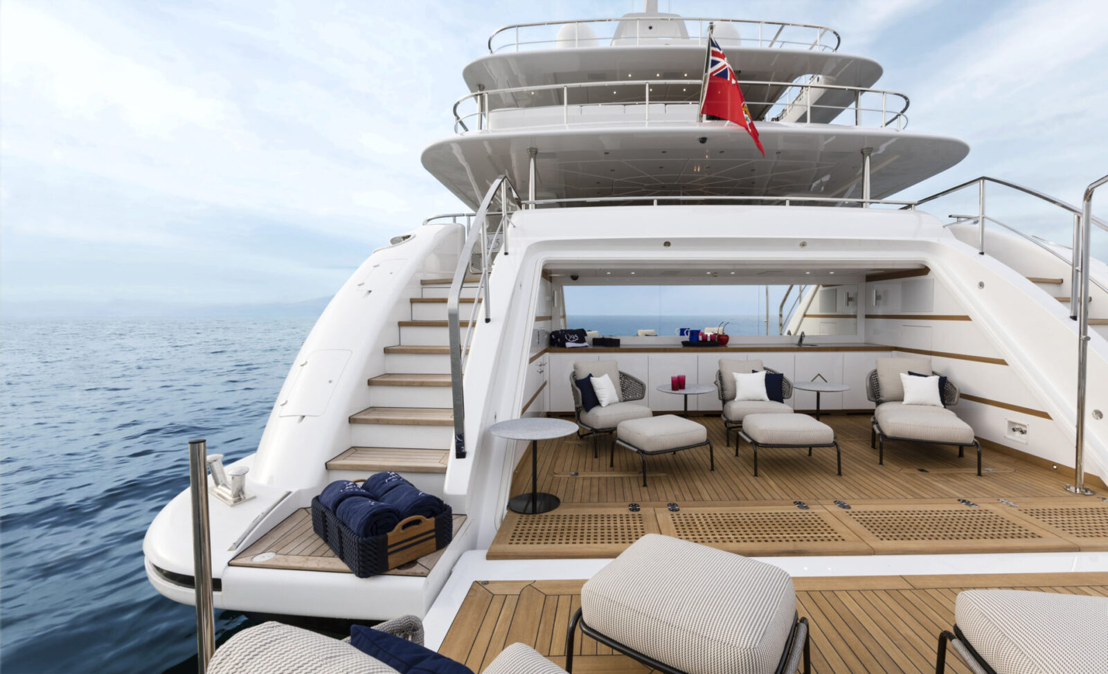 Luxurious yacht deck with seating area at sea.