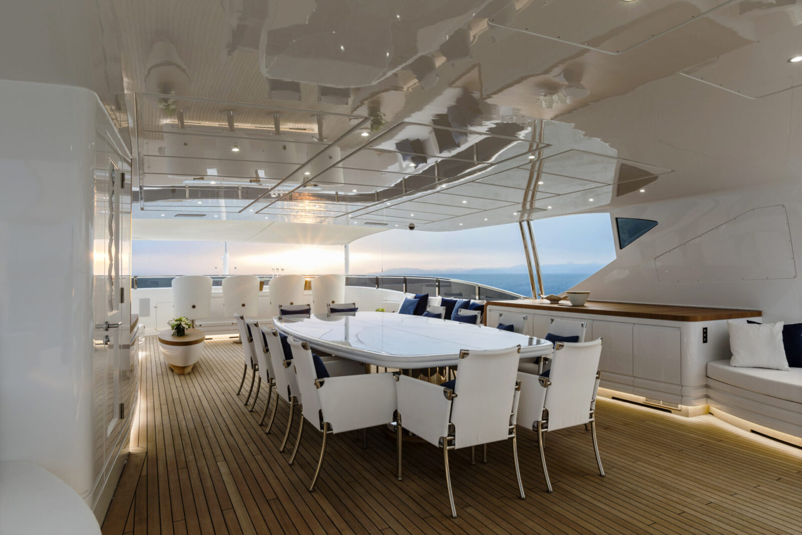 Elegant yacht deck with seating and ocean view.