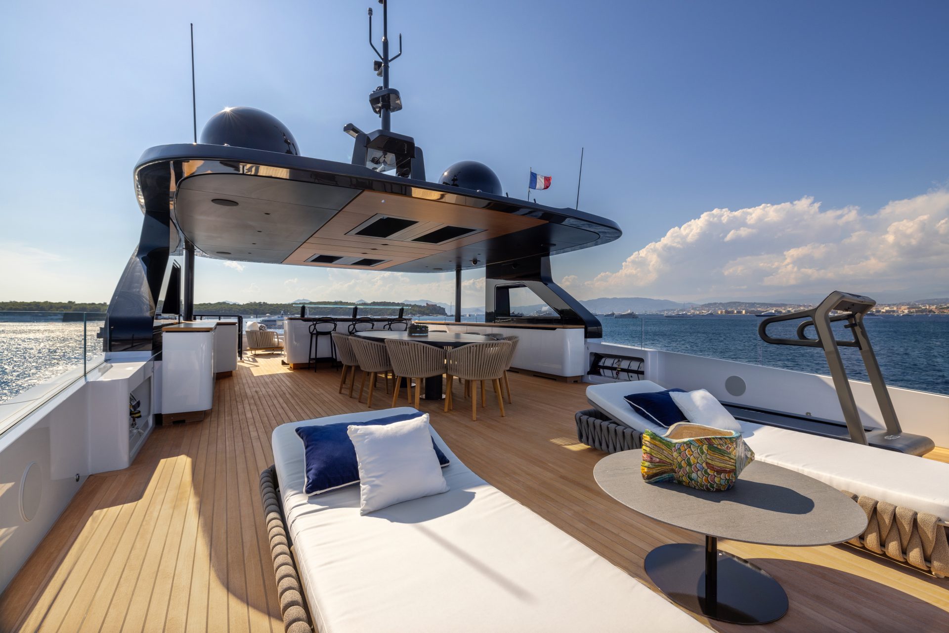 Luxurious deck of a Mangusta yacht at sea.