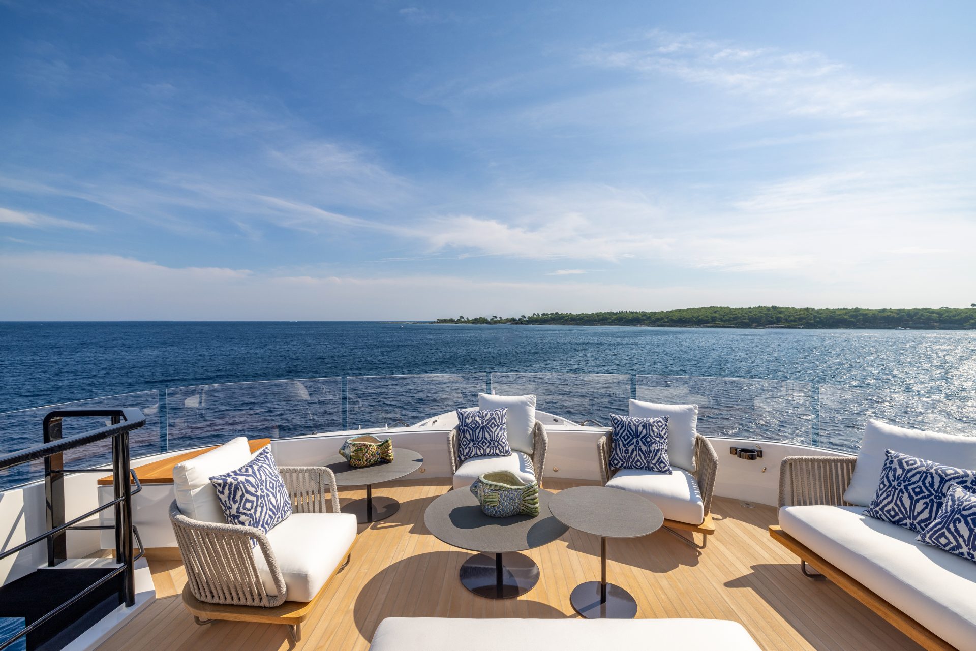 Luxury yacht deck with ocean view and seating area.