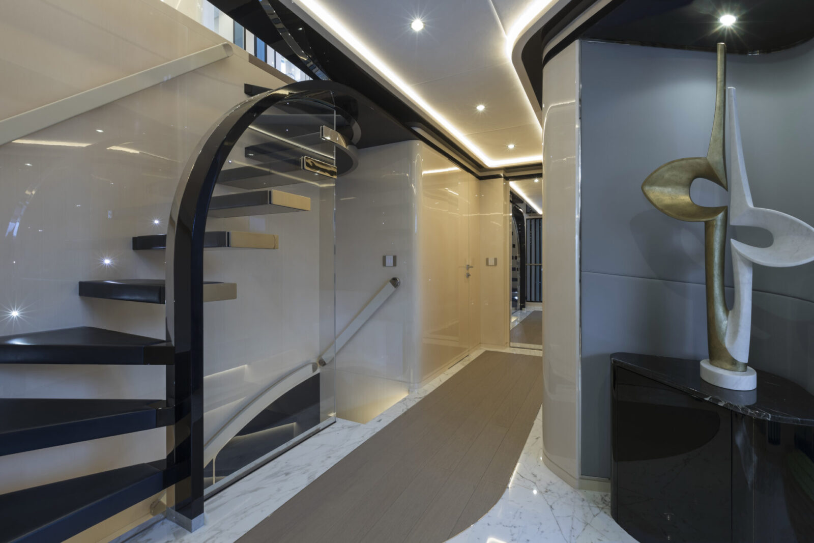 Modern yacht interior with sleek staircase design.
