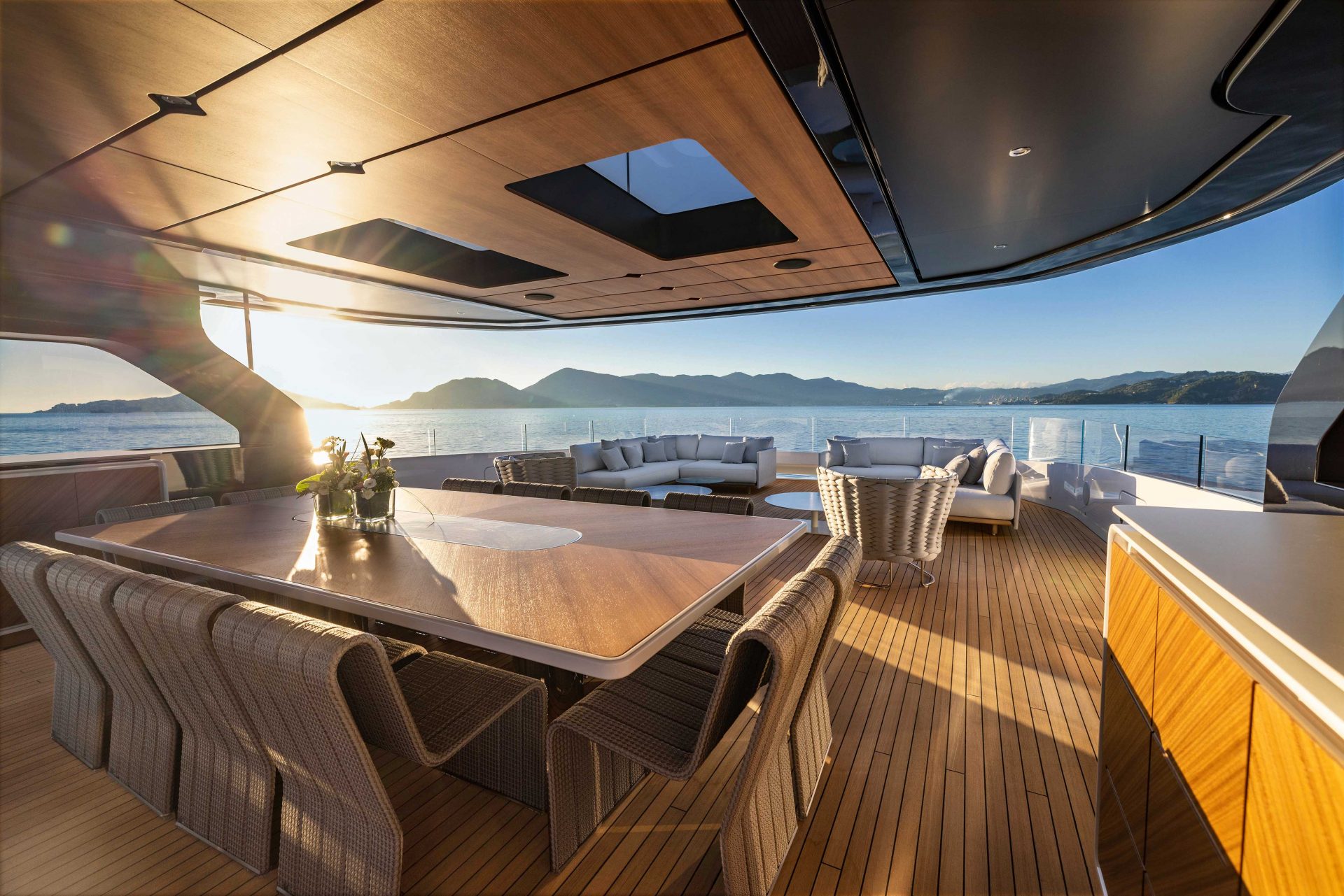 Luxury yacht deck with dining area at sunset