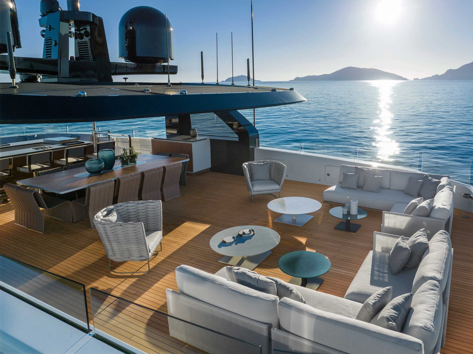 Luxury yacht deck with ocean view and seating area.