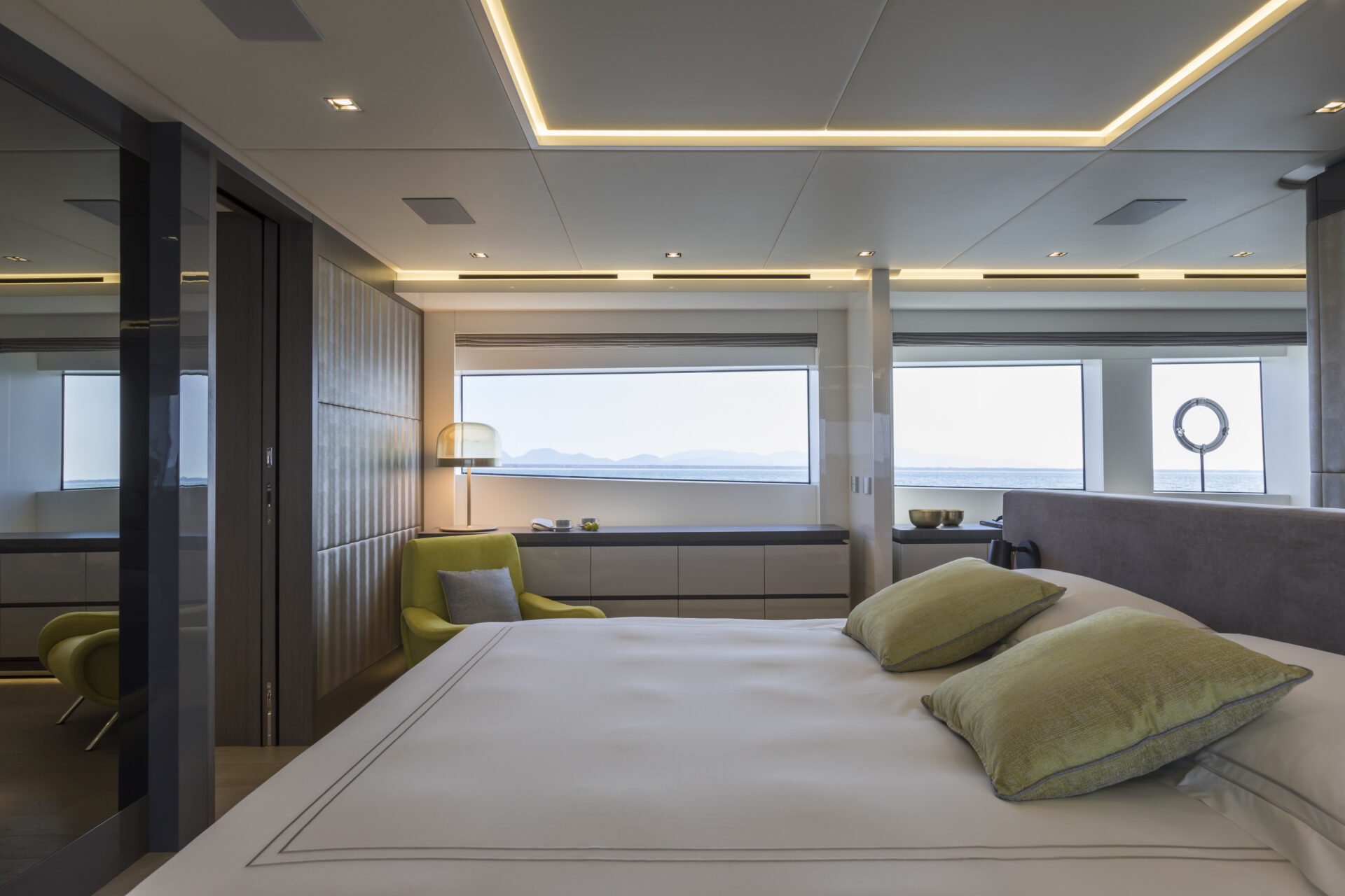 Luxury yacht bedroom with sea view and modern decor.