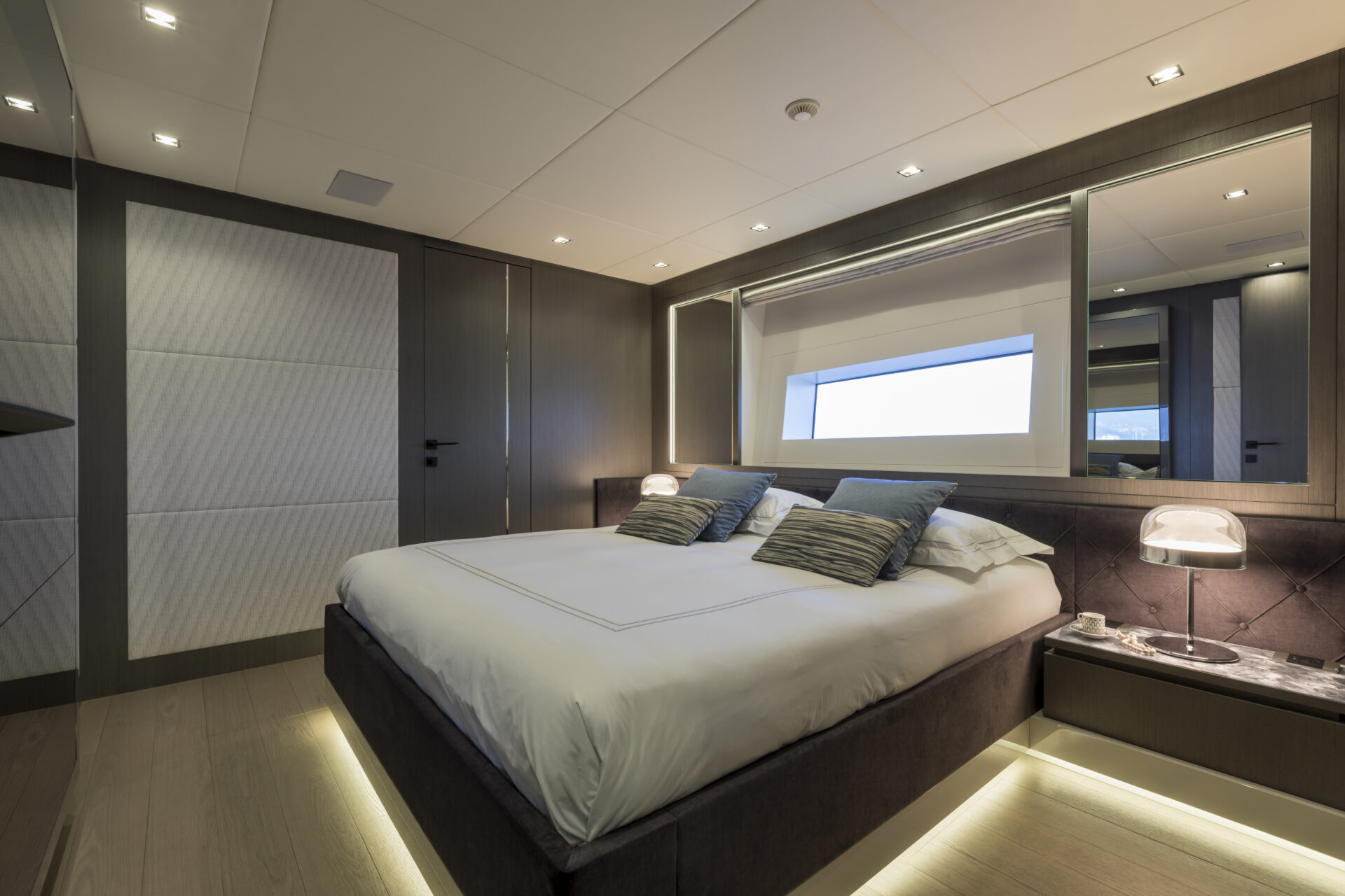 Luxurious bedroom in Mangusta yacht interior.