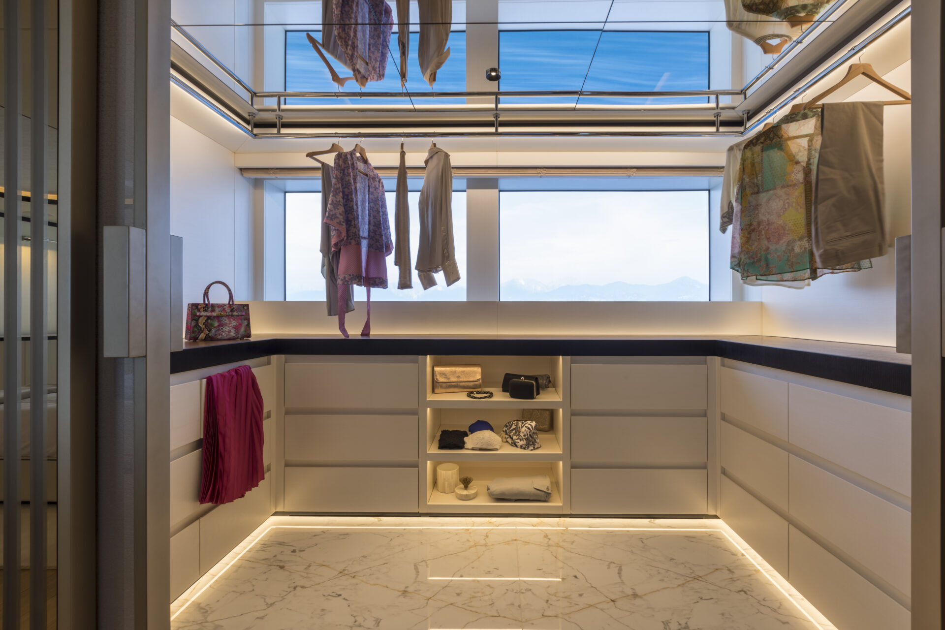 Luxury yacht walk-in closet with ocean view.