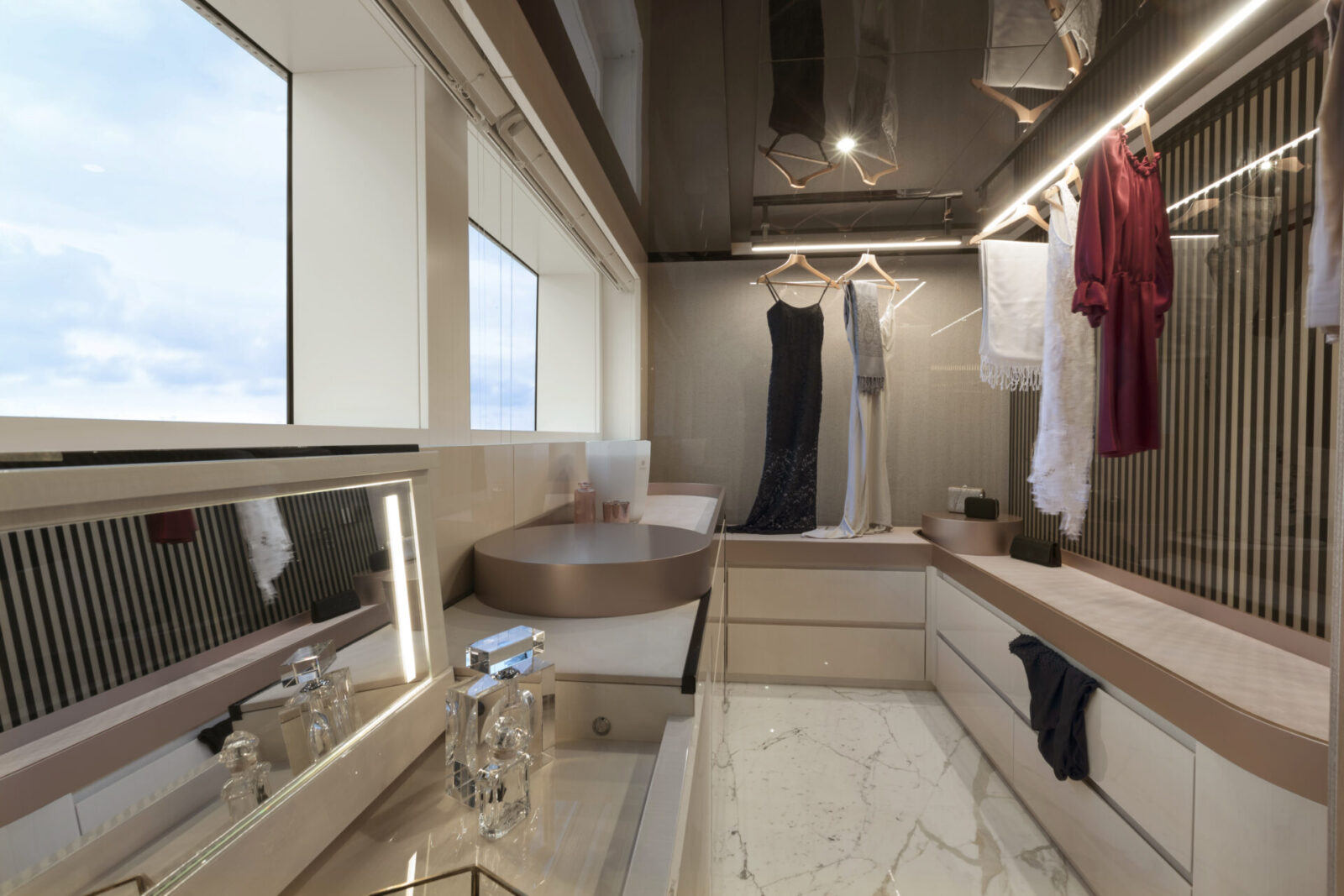 Luxury yacht wardrobe with elegant dresses displayed.
