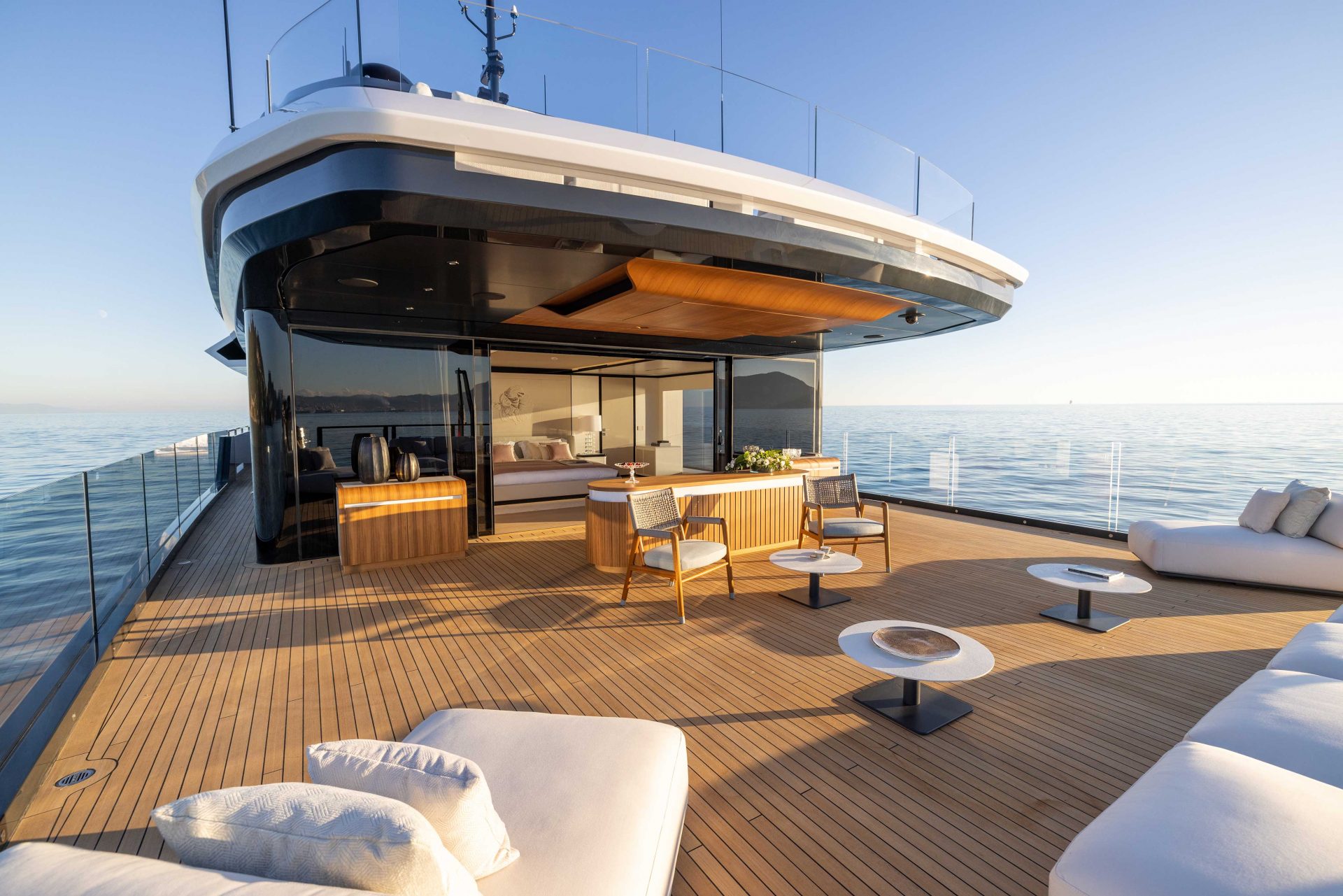 Luxurious deck on Mangusta yacht under clear skies
