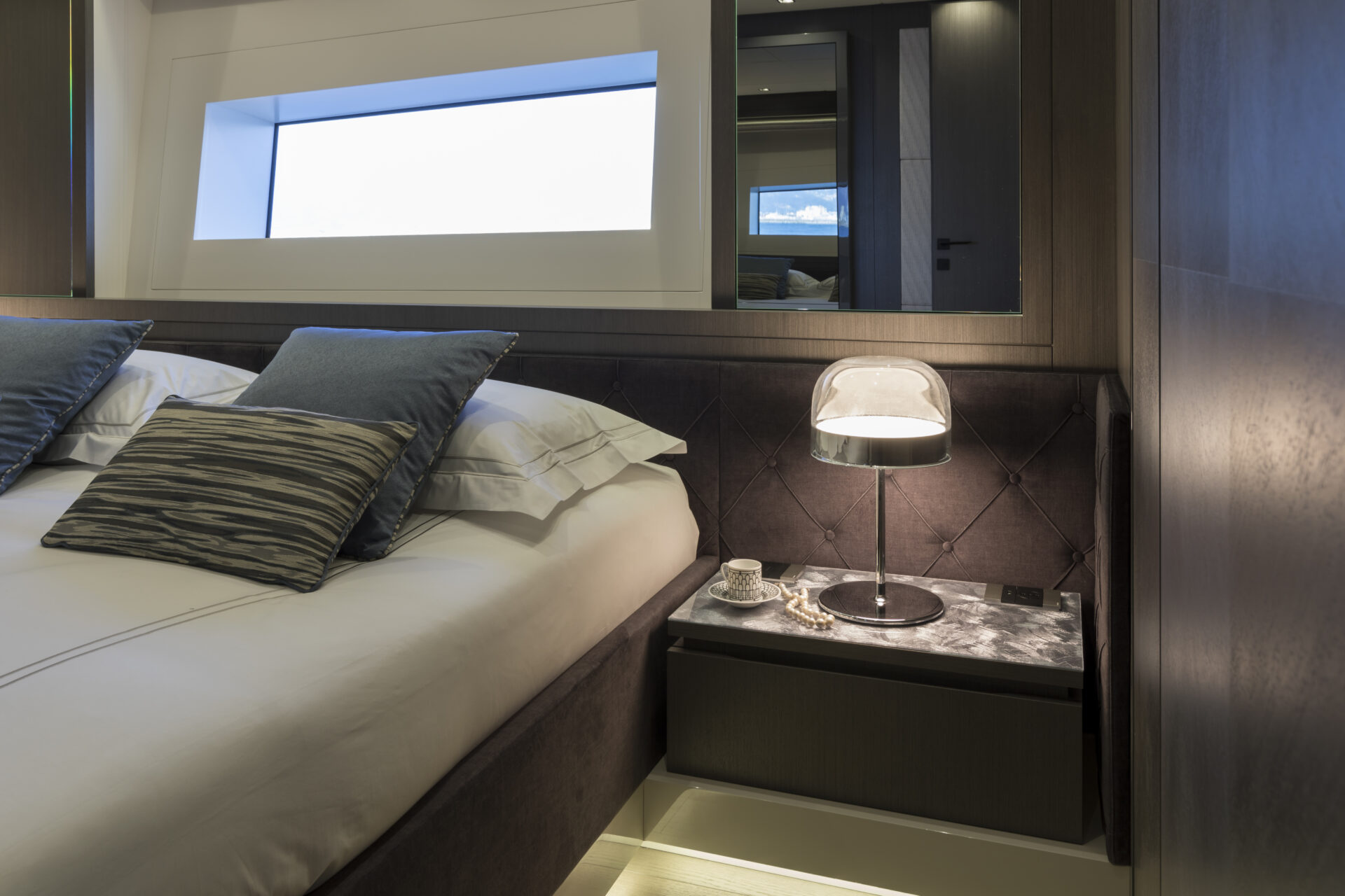 Luxury yacht suite with elegant bedside lamp