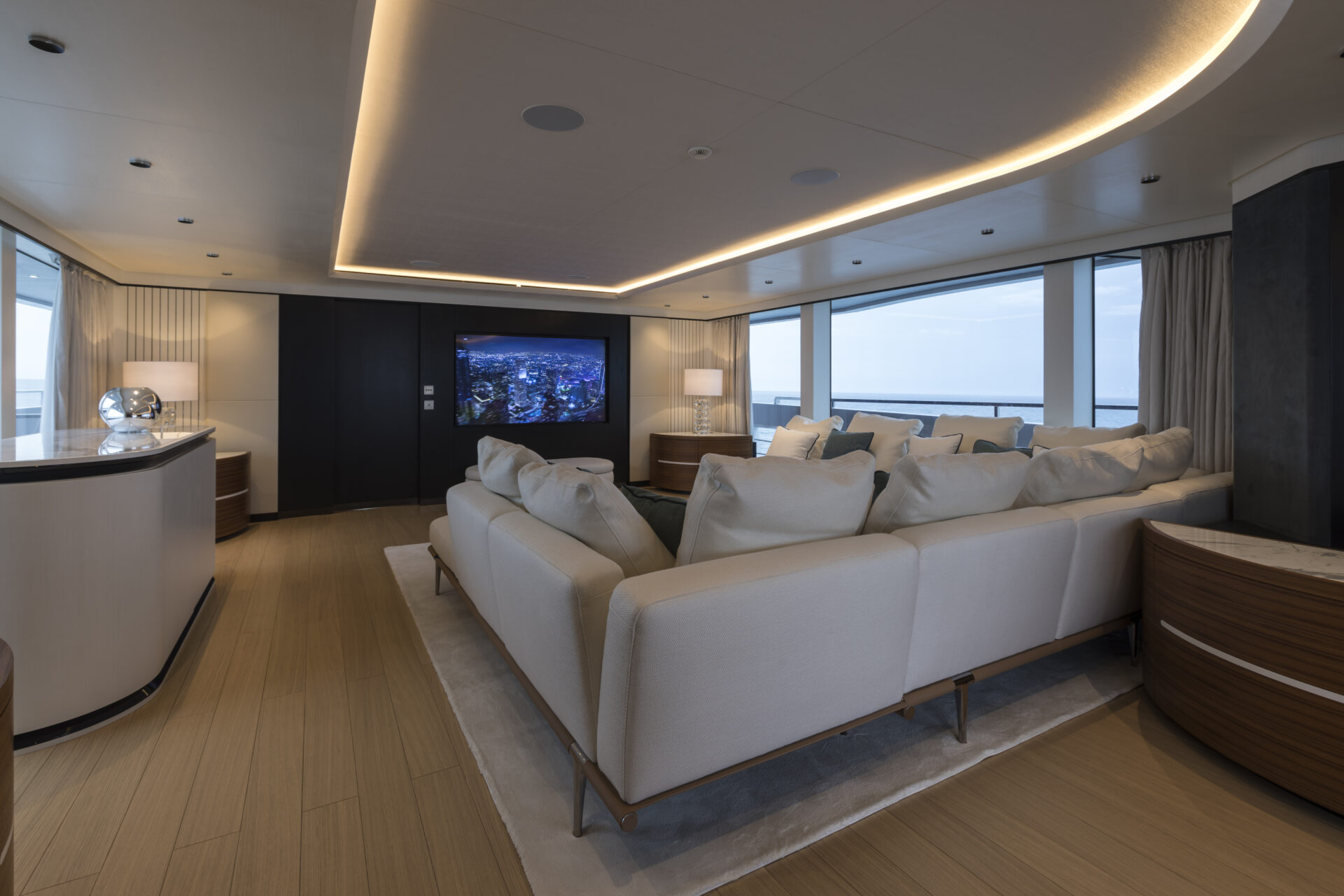 Luxurious yacht lounge with sea view and plush seating.