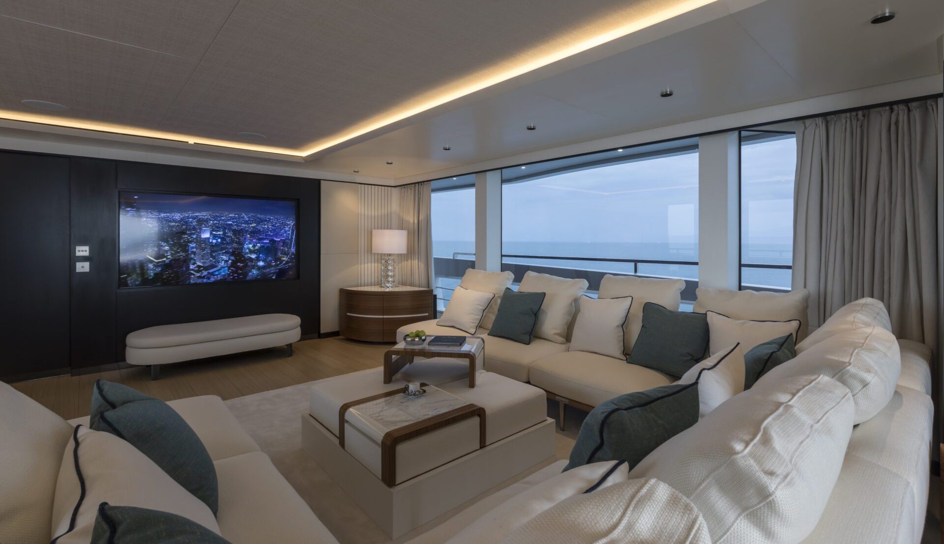Luxury yacht lounge with ocean view and modern decor.