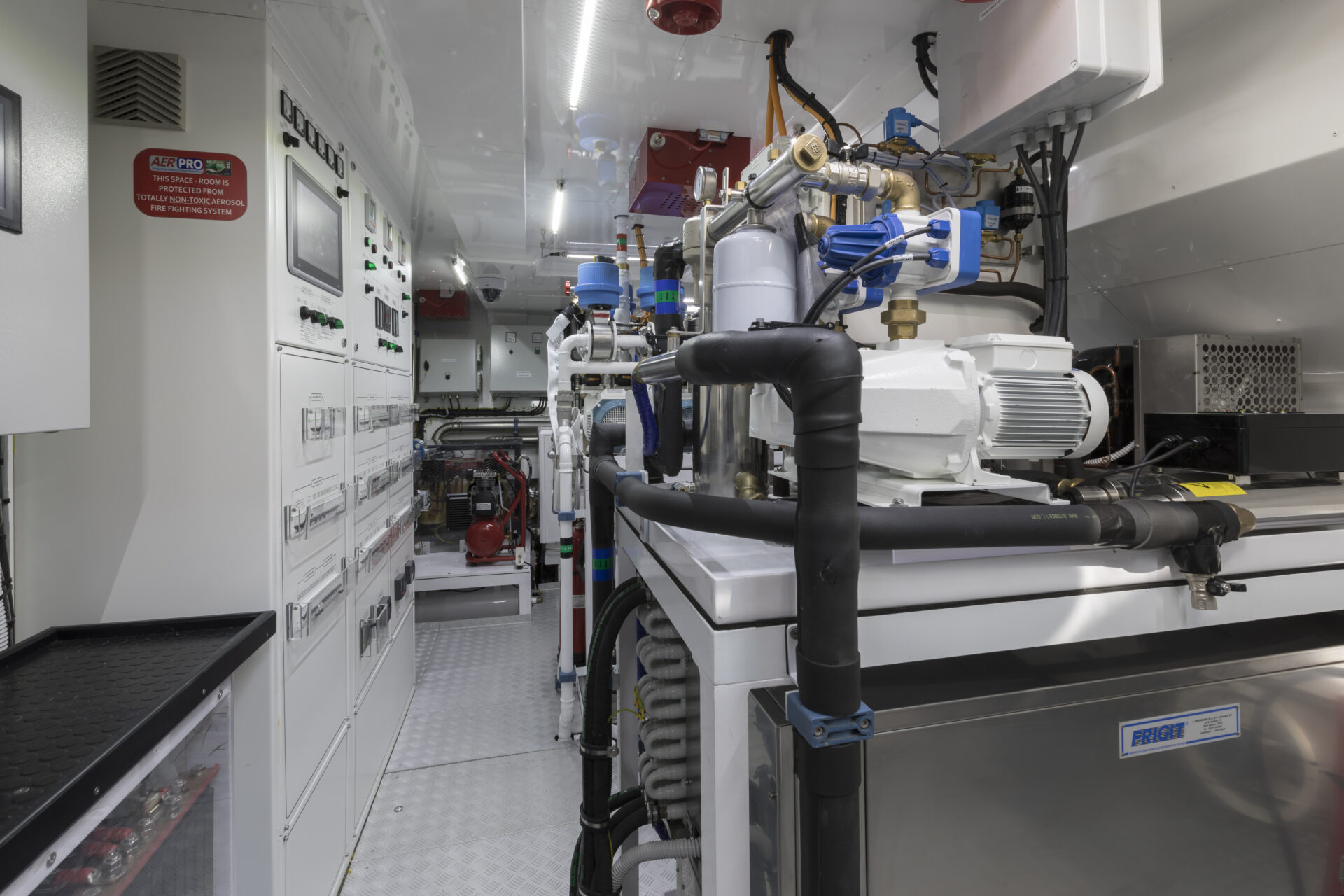 Yacht engine room with control panels and machinery.