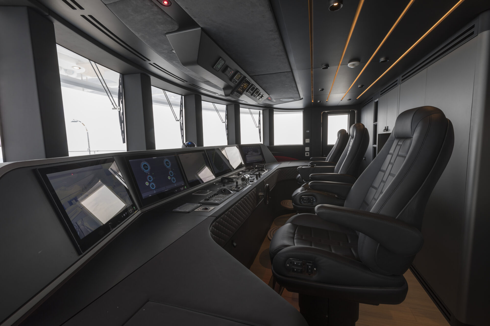 Luxurious yacht cockpit with control panels and seats.