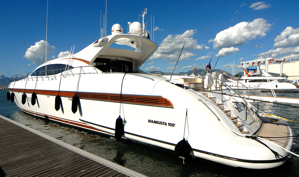 Mangusta 108 yacht docked in sunny marina