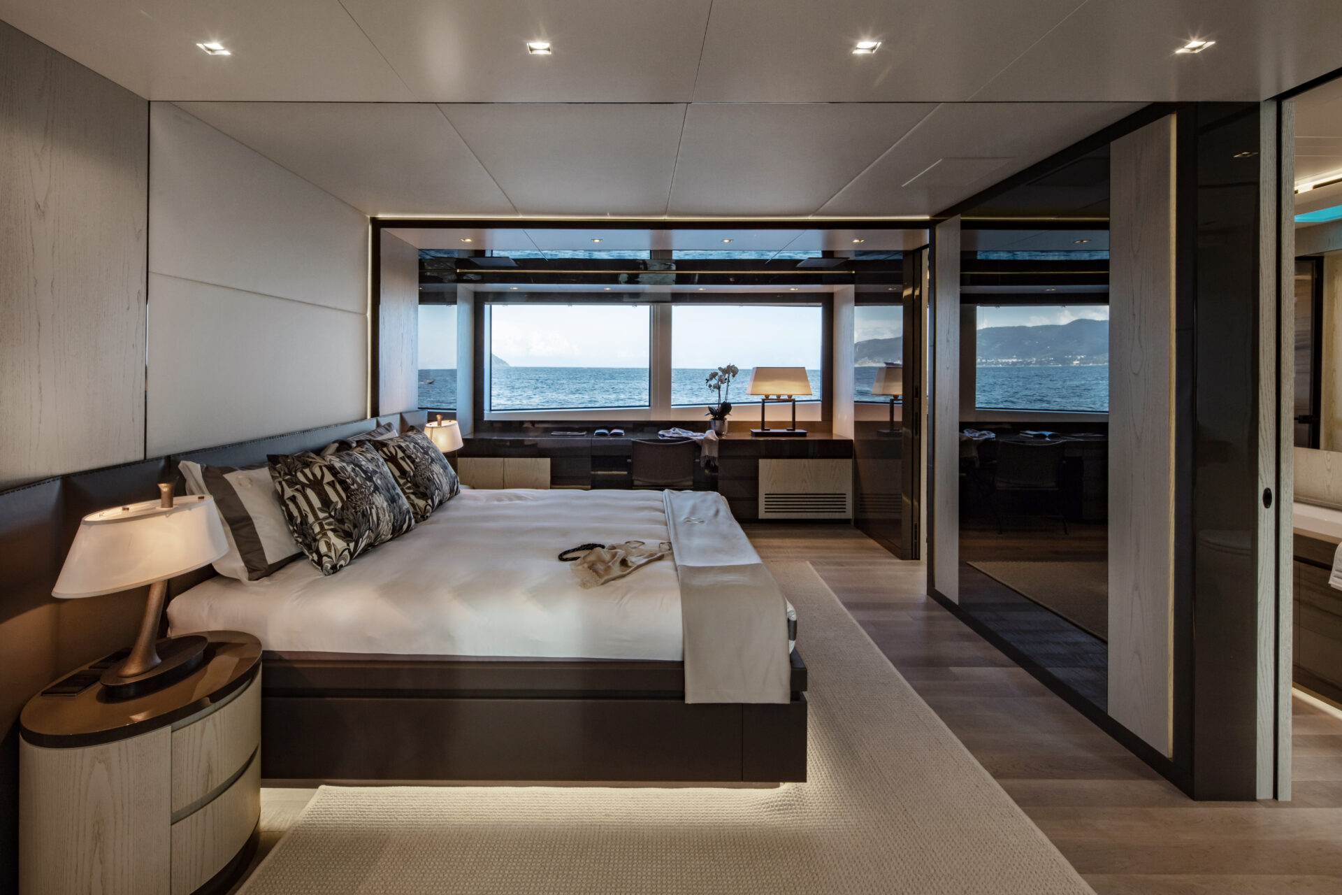 Luxurious yacht bedroom with ocean view window.