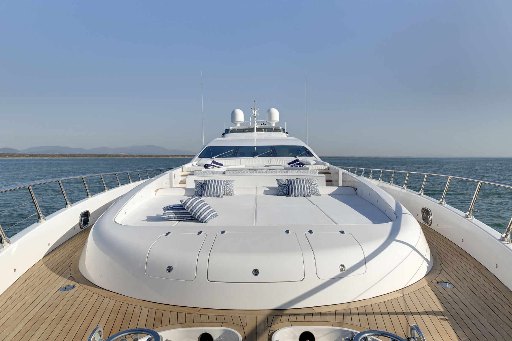 Mangusta yacht deck with blue-striped pillows