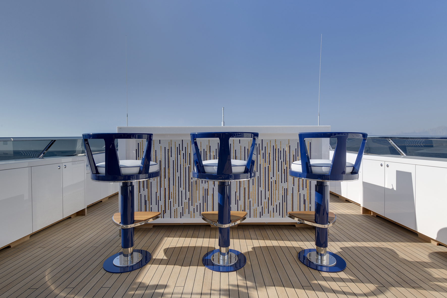 Stylish yacht deck with blue bar stools