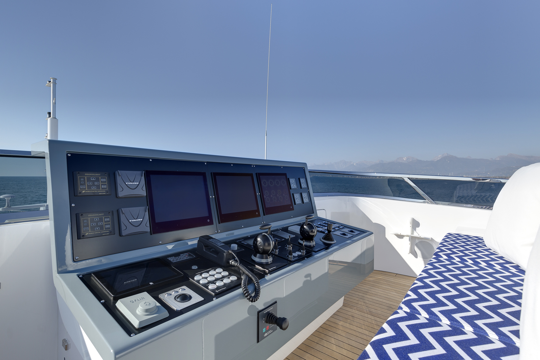 Mangusta Yachts helm with control panels and screens